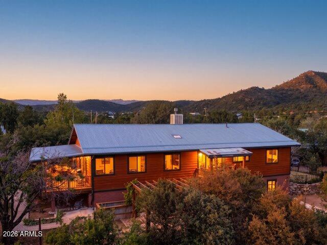 Tucked away near the tranquil East Verde River in the storybook setting of Beaver Valley Estates, this inviting 4-bedroom home offers the kind of lifestyle buyers dream about--peaceful, scenic, and surrounded by nature. Step inside to a warm, open-concept living and kitchen area featuring rich wood floors, expansive counter space, abundant cabinetry, and a large pantry--perfect for gathering, entertaining, or simply enjoying everyday living. The flexible floorplan includes three bedrooms upstairs, plus an oversized downstairs bedroom with its own private exterior entrance--ideal for guests, extended family, or a private retreat. The main suite offers a beautifully tiled snail shower, while a charming Jack-and-Jill bath features a classic clawfoot tub with shower--blending comfort with timeless character. Outdoor living truly shines here. A spacious covered deck, complete with a swing off the main bedroom, invites you to unwind while taking in serene mountain views. The lush, usable property is filled with mature fruit trees--white peach, cherry, apricot, Granny Smith apple, almond, and white table grapes--along with fragrant honeysuckle, lilac, and seasonal blooms. Recent updates include new 2026 underlayment beneath the durable corrugated galvanized steel roof. Additional features include RV parking and plenty of space for multiple vehicles--perfect for hosting or bringing all your outdoor toys. Located within Tonto National Forest, where the river winds through the community, this is a haven for outdoor enthusiasts--hiking, biking, UTV riding, wildlife watching, and stargazing are all right outside your door. Enjoy all four mild seasons in one of Arizona's most charming hidden gems. A rare opportunity to own in this highly sought-after area. Homes in Beaver Valley Estates--especially at this price point--do not come available often. If you've been waiting for the right blend of privacy, nature, and value, this is it.