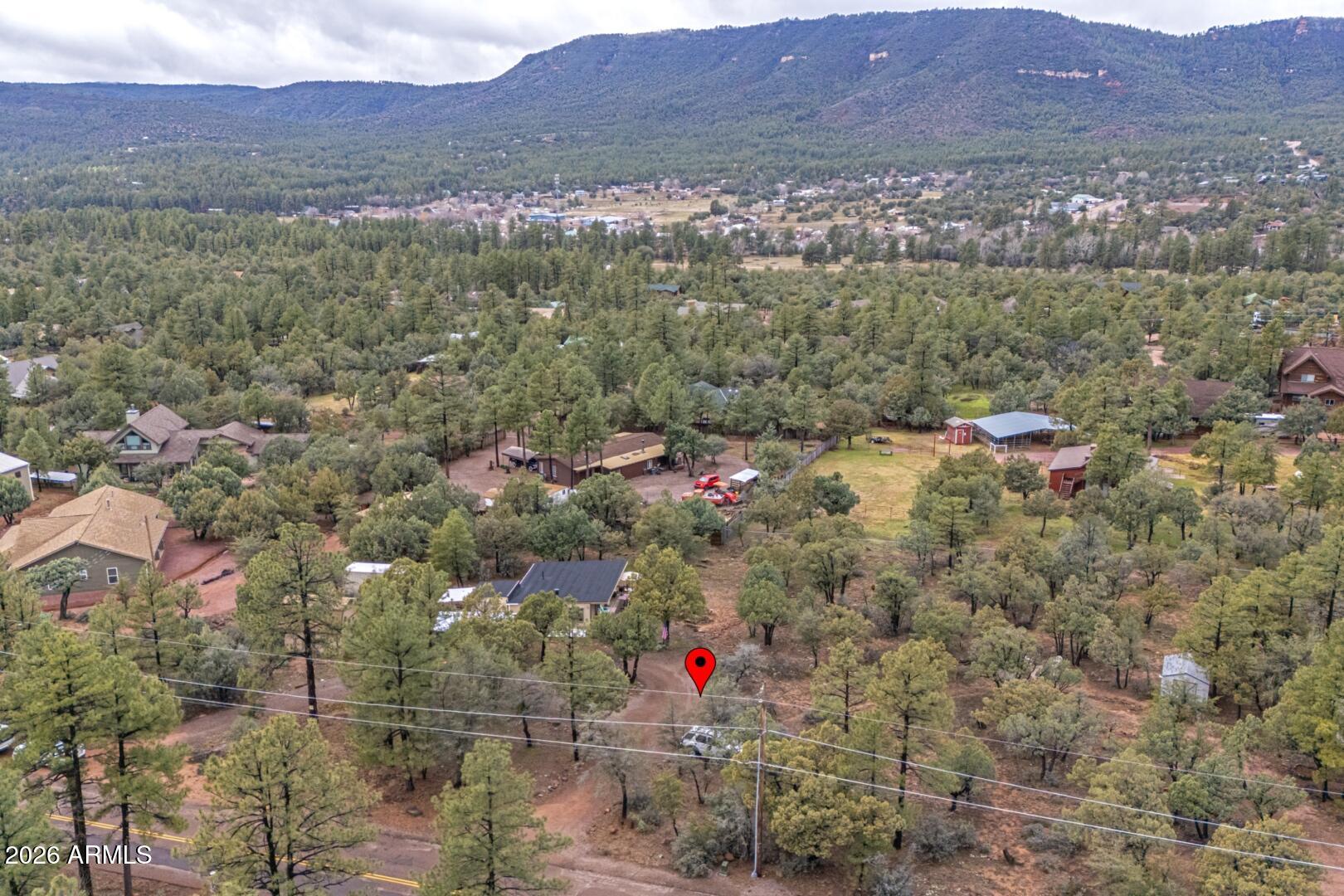 Discover the possibilities at this peaceful mountain retreat in the heart of Pine, Arizona. Situated on a level one-acre lot, this charming 2-bedroom home offers flexibility for a potential third bedroom and features an updated full bathroom. Surrounded by towering Ponderosa Pines and scenic mountain views, the property provides privacy, space, and the true mountain lifestyle buyers seek.

What makes this property especially unique is the expansive one-acre parcel, offering potential opportunities for future expansion, additional structures, guest quarters, workshops, RV storage, or a possible second homesite (buyer to verify all zoning, building, septic, and county requirements). Live comfortably in the existing home while exploring the property's future possibilities. Enjoy direct access to the beauty of Pine with nearby National Forest lands, lakes, hiking trails, horseback riding, fishing, and year-round outdoor recreation just minutes away. The level lot offers ample room for horses, RV parking, recreational vehicles, and all your mountain toys.

Located at approximately 5,400 feet in elevation, you'll enjoy cool summer temperatures, mild winters, and four distinct seasons. Whether you're looking for a primary residence, vacation getaway, multi-generational property, or investment opportunity, this property offers a rare combination of livability, usable land, and future potential.

Buyer to verify all information regarding lot split potential, additional dwelling units, building rights, utilities, septic capacity, and county development requirements.