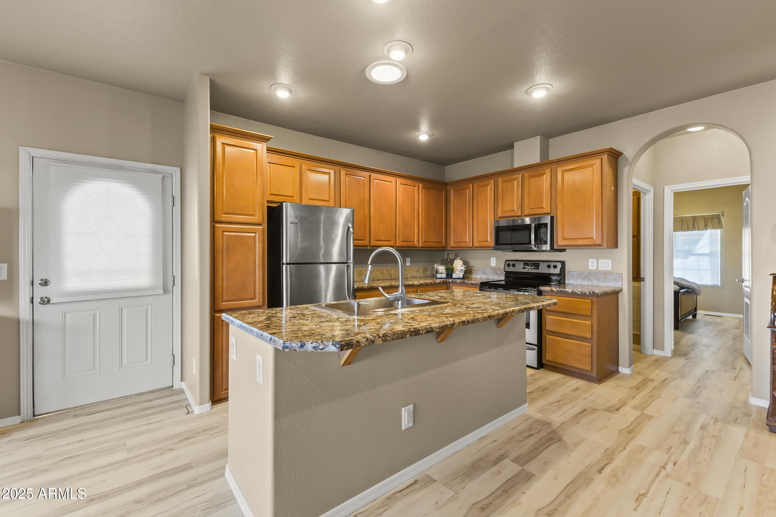 Welcome HOME! Newly remodeled 2015 Cavco nestled on the 14th hole in the active adult community of Pueblo El Mirage RV Resort. 1 bedroom/1.5 bathrooms, 739 sqft on a 2200sqft lot. Home features- new laminate flooring, fresh paint, baseboards and new bathroom vanities.  A large kitchen island with upgraded sink and plenty of cabinetry. Bedroom has a walk in closet and private bathroom.  Sizeable laundry room with stacked washer/dryer and plenty of shelving/storage. Outside features- shed with electrical power, security gate on front door, sunshades, awning coverage, golf ball protective screen and a patio to enjoy the stunning views of the golf course. Community offers a wide array of amenities(library, swimming pool, golf course, pickleball, crafts, entertainment and more). It's a BEAUTY!