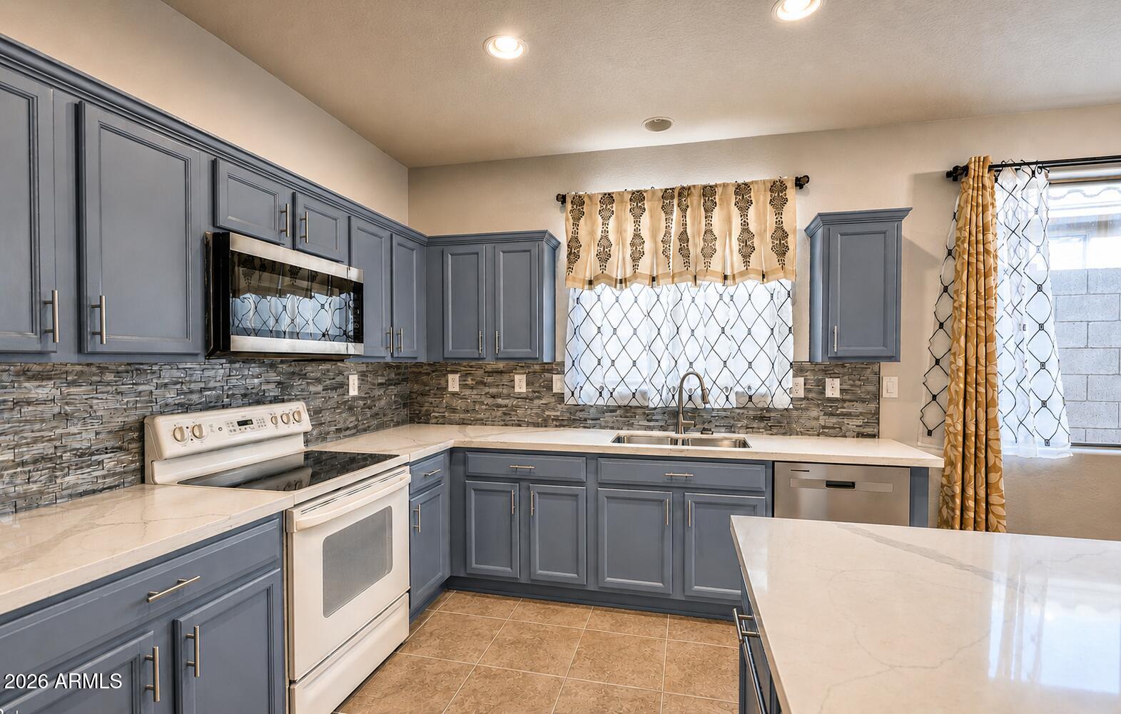 Popular Holiday model with 4 bedrooms, 2 baths, formal living and dining plus family room all on a single level. Just around the corner from shopping, dining and award-winning Gavilan Peak K-8 school. Brand new quartz kitchen counters, floor tile, security doors on front and back patio. Remodeled primary bath with walk-in shower. Included blinds and drapes, soft water system, ceiling fans in all rooms, surround sound, and recently replaced water heater. Peaceful desert backyard and extended patio. Epoxy garage floor with built-in storage cabinets.