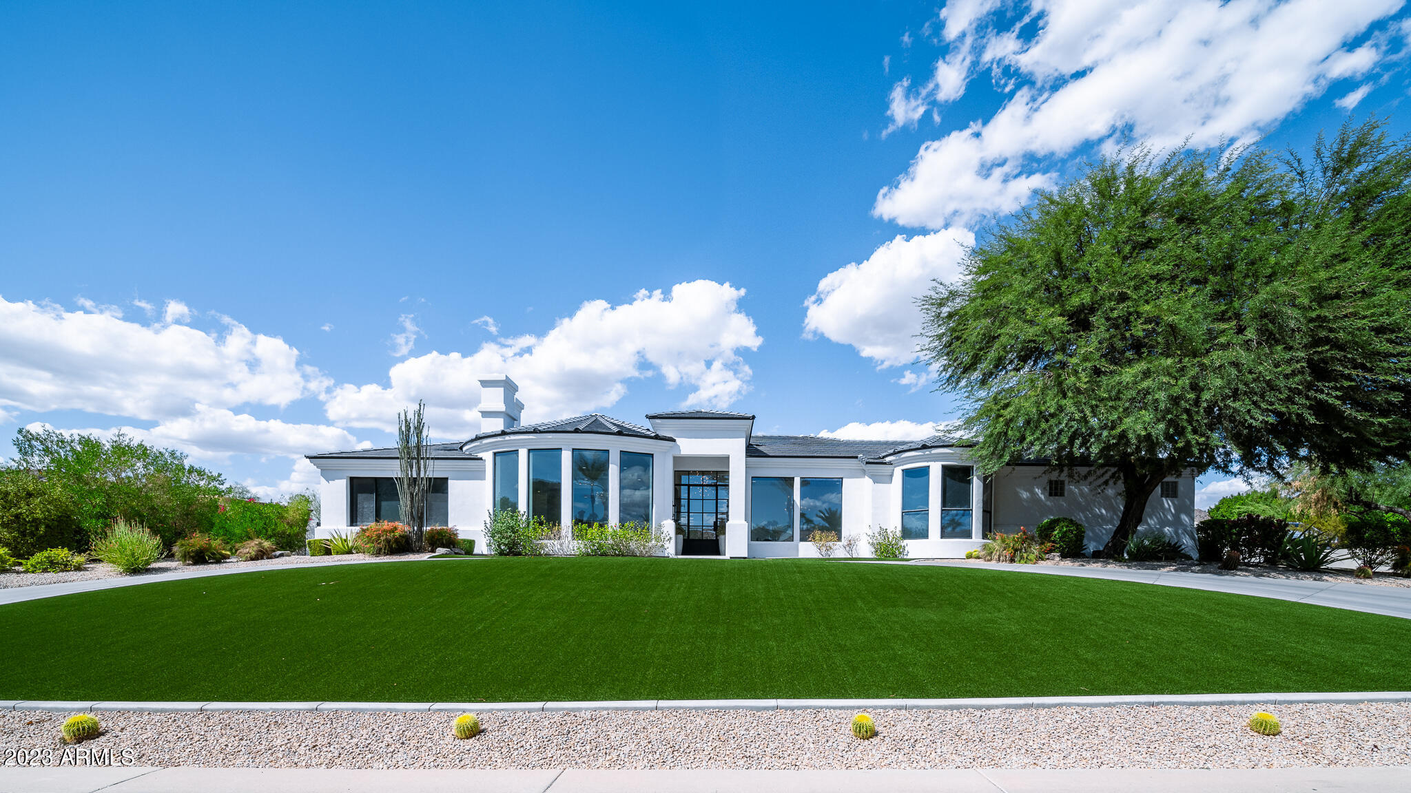 Views! Views! Views! Recently remodeled, this stunning home is sure to impress! The floor to ceiling glass windows draw you in, creating light and bright open concept living.Imported Italian 36'' porcelain tile & hardwood throughout. Step into the chef's kitchen featuring custom handmade cabinetry, Sub-Zero/Wolf appliances, and a stunning Calacatta white marble island. The desirable split floor plan makes the home perfect for everyone. The primary bedroom is inviting and includes a custom coffee bar and beverage center. and the additional guest bedrooms are all en-suite with large walk-in closets. The bathrooms showcase Italian marble wall tile and gorgeous polished nickel fixtures. Huge lot with resort-like, brand new pool, limestone pavers and custom landscaping(artificial turf) with separate sitting area to enjoy perfect sunset views of Camelback Mountain.