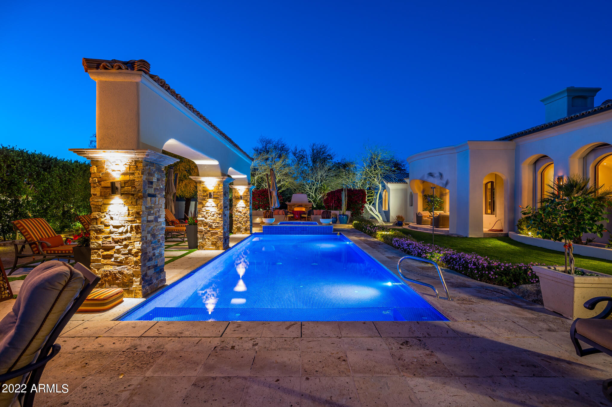 Beautifully crafted custom Gary Gietz estate nestled at the base of Mummy Mountain.  The design and craftsmanship of this home showcase the architectural details and are complimented by the flowing interior exterior spaces. The Chef's kitchen has Wolf and SubZero appliances along with butler pantry.  Family opens to both the kitchen and fabulous outdoor living room.  The desirable split floorplan offers a private primary suite with spa like bath and adjacent office/ 4th bedroom featuring a private courtyard with fireplace and viewing deck.  800+ bottle wine closet, smart home system, 6 fireplaces throughout, owned solar panels, a fantastic 5-star resort-like backyard with multiple seating areas, tile pool and spa, bocce ball court, fountain with fire feature and so more more.