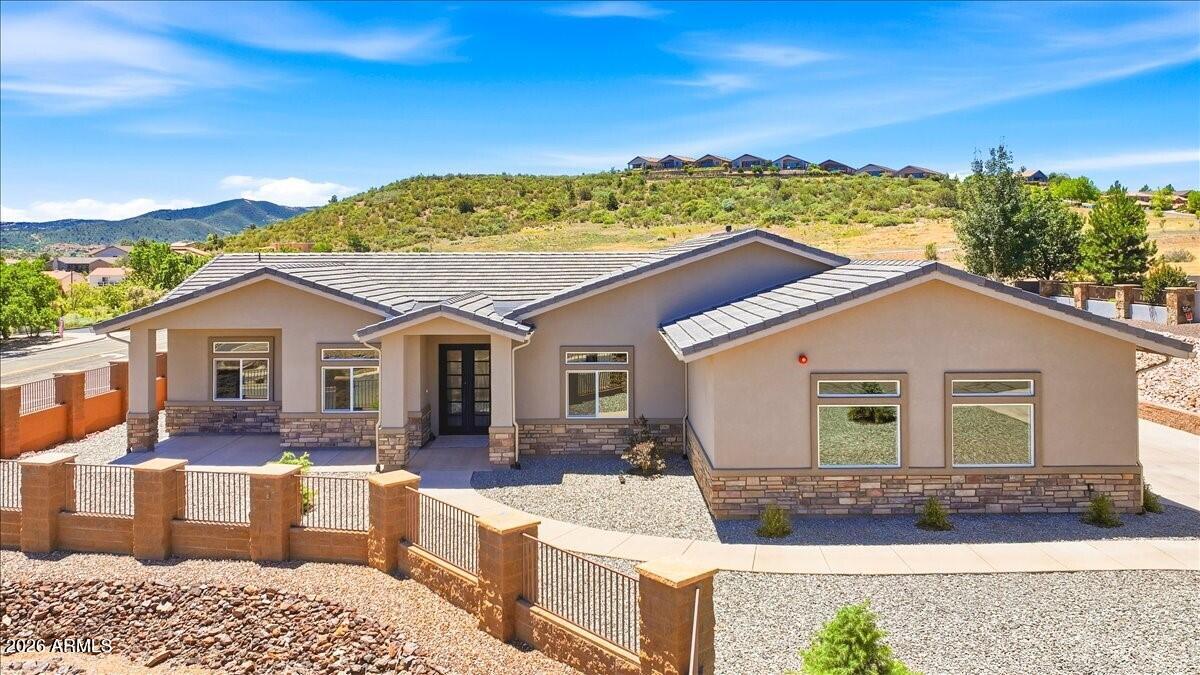 Fabulous NEW Custom Build on large .39 acre Corner Lot in Desirable/Gated BLOOMING HILLS ESTATES with VIEWS, across the street from popular Rollie Simons Community Center in Beautiful Prescott, Arizona!!!  Great CURB APPEAL with Tile Roof, Stacked Stone Accents, & Colored Concrete Walkway/Driveway/Patio leading you to Large Covered Front Patio.....Enter this Beautiful 2711 Square Foot 3 Bedroom, 2 Full Baths, Oversized 3 Car Garage w/Epoxy Floor, plus Den/Office or 4th Bedroom, Open/Split Floor Plan, GREAT ROOM Concept, 2 Tone Paint, Electric Fireplace, Ceiling Fans & other Upgraded Lighting plus High-end Wood-plank Laminate Flooring. Gourmet Kitchen fully equipped with Stainless Steel Appliances (8 Burner Commercial Range/Oven w/Flat Grill attachment, Stainless Steel Range Hood, White...