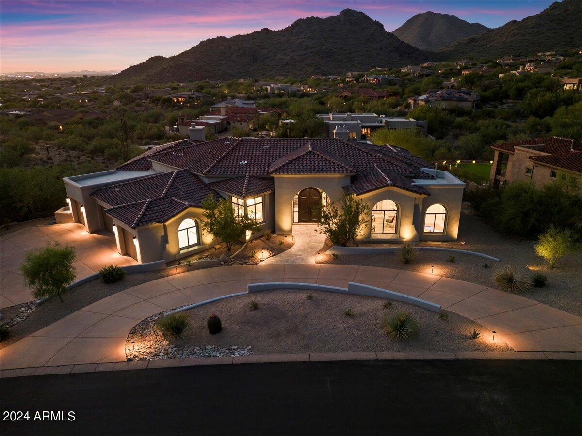 Elevated Extravagance! Ricci Renovations unveils another jewel within The Retreat at One Hundred Hills, a guard-gated community in McDowell Mountain Ranch. Views from every room, the transformation was just completed, ready for enjoyment & memories to be made. A freshly painted exterior w/ travertine entry leading up to the 12' arched wood front door provides a terrific initial impression. Upon entering, you immediately notice the new 10' sliders framing the new pool & majestic mountain views. The brand-new European oak wood floors are gorgeous & run throughout the main areas while hand-selected tiles differ in each bath. The spectacular kitchen offers an all-new Thermador appliance package, Perlato Taj Satin quartzite counters waterfalling on 3 sides that sit atop rift oak & macaron green counters. The locally custom-made Supra Mat & textured laminate cabinetry bring warmth & luxury to this fabulous estate. 
The primary suite showcases a 14-light centerpiece pendant & a gas fireplace wrapped in matte charcoal tile with aspen logs. The primary bath is an oasis with floating cabinetry, Calacatta Maywood quartz counters, soaking tub, redesigned/oversized shower with his and her heads, all adorned with brilliance black onyx Brizo finishes. The closet is spacious, also with custom cabinets, plus there's a dedicated exercise room.
The built on-site gas fireplace, 72'' linear open face with herringbone brick & glass bed, in the family room is a showstopper. It overlooks the city below providing the perfect gathering spot. Other features include a Chevron pattern ship-lapped wall in the office, deco tile accent wall in powder & carbon reflective glass tile with light-embedded floating shelves on the bar. 
The newly added guest suite is spacious (15'x13') and so is its ensuite bath with custom cabinetry & tile. The other 2 guest rooms on the opposite wing also offer ensuite baths with floating cabinetry, Ripieno satin quartz counters & faucets/showers with Brizo selections. All 3 provide walk-in closets. 
The backyard is ideal, covered in silver storm travertine that surrounds an all-new sparking pool, spa, deco-tiled water feature wall, firepit, BBQ station & large turf area. The backdrop of city lights & the McDowell Mountains are incredible, day or night. The 4-car garage has all-new epoxy flooring & lighting. A new roof underlayment in 2023 has a transferable lifetime warranty. HVAC units were replaced in 2012, serviced in 2024 & are in great working condition. 2 new water heaters & a water softener.
The community has a heated pool & spa alongside 2 tennis courts. There are also 2 more community centers within MMR that offer pickleball, tennis, basketball, playgrounds, pools, hiking & biking trails as well as an aquatic center. North Scottsdale living at its finest.