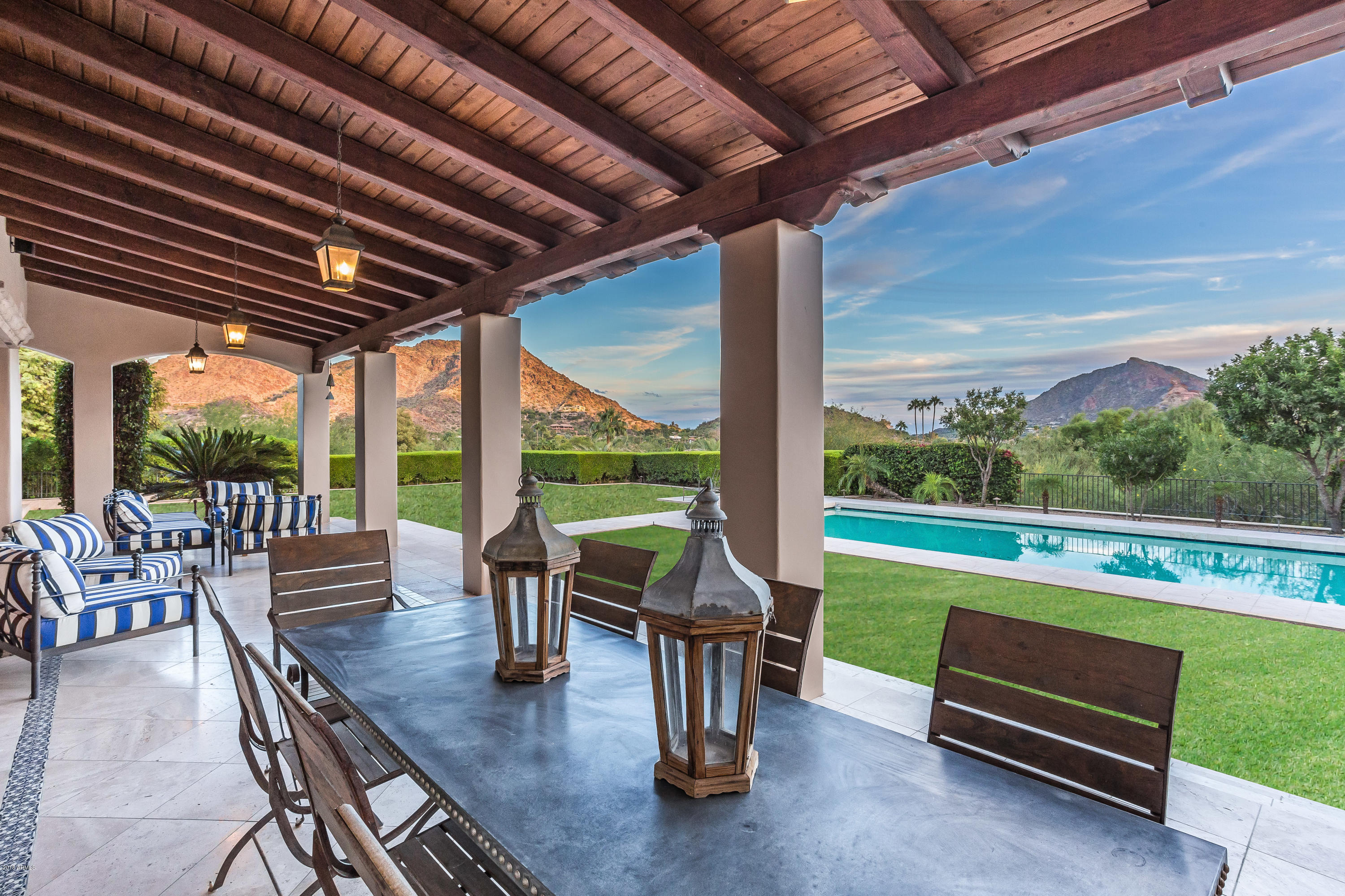 Arizona living does not get any better than this. Absolutely spectacular home set in the heart of Paradise Valley with drop dead gorgeous views in every direction.  Rebuilt in 2003 and then renovated in 2018 this is truly a one of a kind estate. Main house has 4 bedrooms all with ensuite baths, charming home office,  gourmet kitchen with quartz counters and commercial stainless appliances, 5 fireplaces and 2 powder baths. Beautiful wood flooring throughout, soaring white brick and beamed ceilings and walls of windows and doors to the backyard oasis. Large play pool and a covered patio that runs the length of the home. One bedroom, one bath casita with living area, outdoor shower and private patio. No expense spared in this incredibly private oasis on a breathtaking level lot. A must see!!!