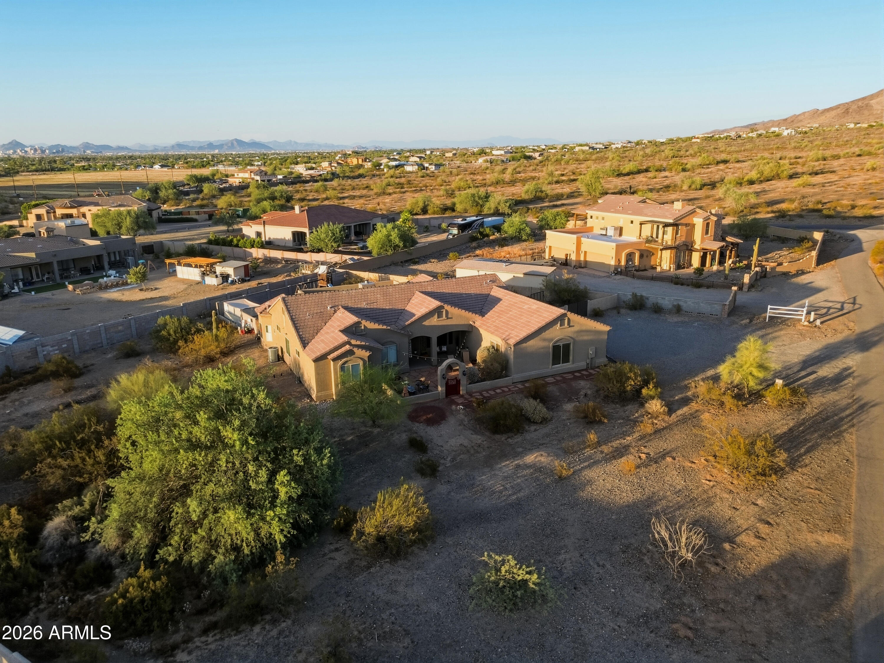 One-acre custom home with breathtaking panoramic views of South Mountain, Carver Mountain, the Estrella Mountains, and sparkling city lights. Nestled in a quiet, private setting with no HOA, this exceptional property offers the perfect blend of luxury, space, and convenience. The open-concept floor plan is designed for both everyday living and entertaining, featuring a gourmet kitchen with abundant cabinetry, generous counter space, and seamless flow into the living and dining areas.
Enjoy Arizona's spectacular sunsets from the inviting courtyard or relax beneath the expansive covered patio while taking in the surrounding mountain views. The luxurious primary suite is a private retreat featuring a spacious walk-in closet and a spa-inspired bath with a claw-foot soaking tub, perfect for relaxing while enjoying the peaceful surroundings. Large secondary bedrooms provide comfort and flexibility for family and guests.

The oversized 3.5-car garage features extra-tall doors, abundant storage, and ample room for vehicles and equipment. The one-acre lot offers endless possibilities with space for a guest house, RV garage, workshop, pickleball court, pool, or additional outdoor amenities. Bring your RV, boats, trailers, and toys--there's room for it all.

Ideally located just minutes from the South Mountain Freeway, Sprouts, shopping, restaurants, Downtown Phoenix, Sky Harbor Airport, ASU, and convenient access to both the East and West Valley.