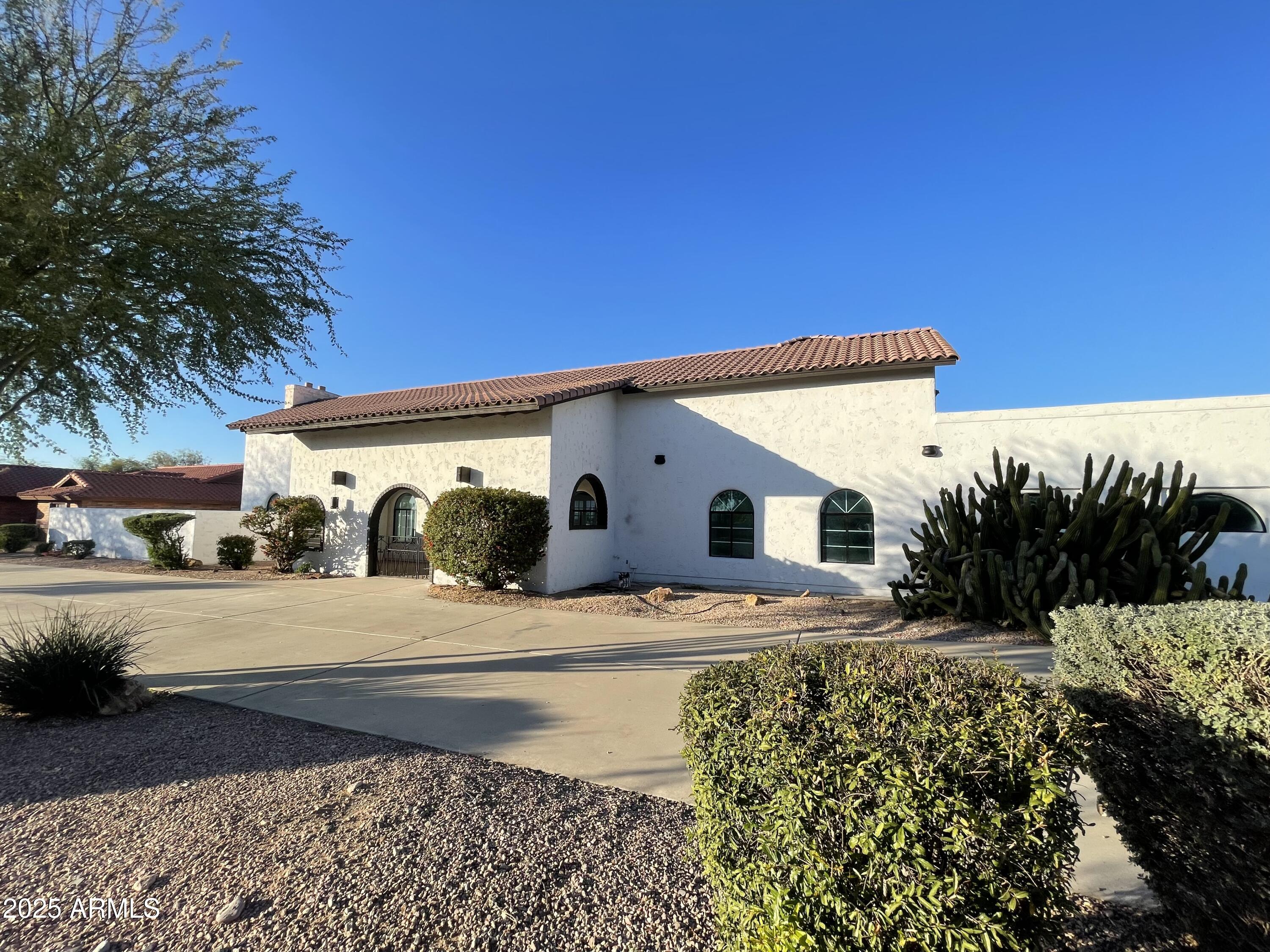 Unique, BASEMENT HOME with R-6 ZONING and NO HOA! Conveniently located right here in Glendale, Arizona, only 2 miles to WESTGATE Entertainment District & STATE FARM STADIUM! This 7,000 sq ft. masterpiece is nestled on nearly a 1 ACRE LOT.  This TRILEVEL home features 4 spacious bedrooms, 4.5 bathrooms, SWIMMING POOL and a 3-car garage.  BASEMENT offers a huge gathering room with FIREPLACE and BAR along with 1-bedroom, full bath, and EXTRA-LARGE BONUS ROOM 22X20 or 5th BEDROOM.  Main level hosts beautifully UPDATED KITCHEN, FAMILY ROOM with FIREPLACE, full bathroom, and formal dining room. Master suite boasts a cozy SITTING ROOM with 2-WAY FIREPLACE.  Upper level features a LOFT AREA, 2 bedrooms with a JACK & JILL BATHROOM, plus entrance to HUGE OUTDOOR BALCONY.  Endless possibilities