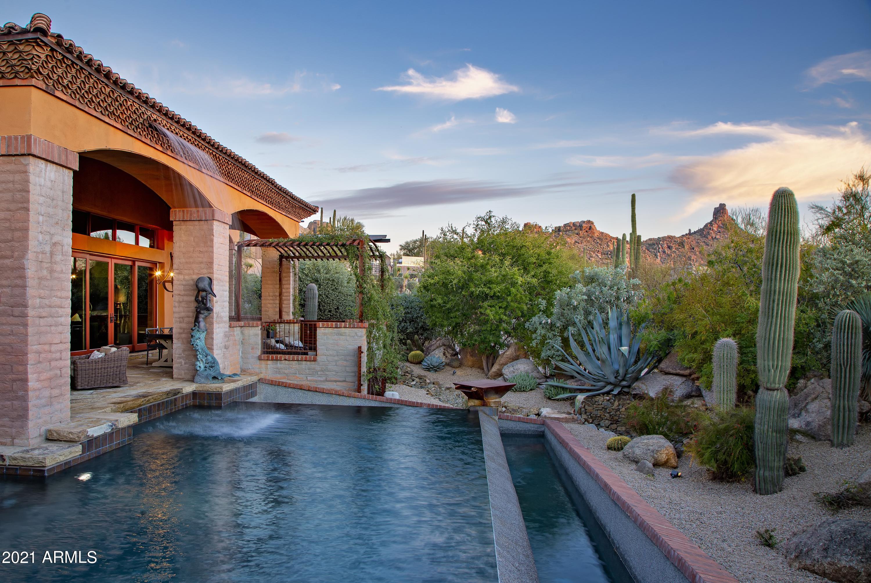 Elegant Old World charm and craftsmanship in the guard-gated community of Estancia with sunset and mountain views * Exceptional floor plan with the flexibility to offer 4 bedroom ensuites plus an office or his/her offices * The chef's kitchen opens to the family room and flows seamlessly to the outdoor entertaining space perfect for entertaining * Enjoy outdoor living with winter sunsets from a large covered patio with dining and sitting areas, heated pool with spa and water features, outdoor kitchen with BBQ, gas firepit and fireplace and a view deck with panoramic city light views * Interior details include slate stone and wood plank flooring, stacked brick feature walls, beamed ceiling details, multiple gas fireplaces, a full wet bar and temperature controlled wine cellar * The private master suite includes his and her vanities, large soaking tub, fireplace, large closet and adjacent exercise room * A 3-car garage completes the residence *