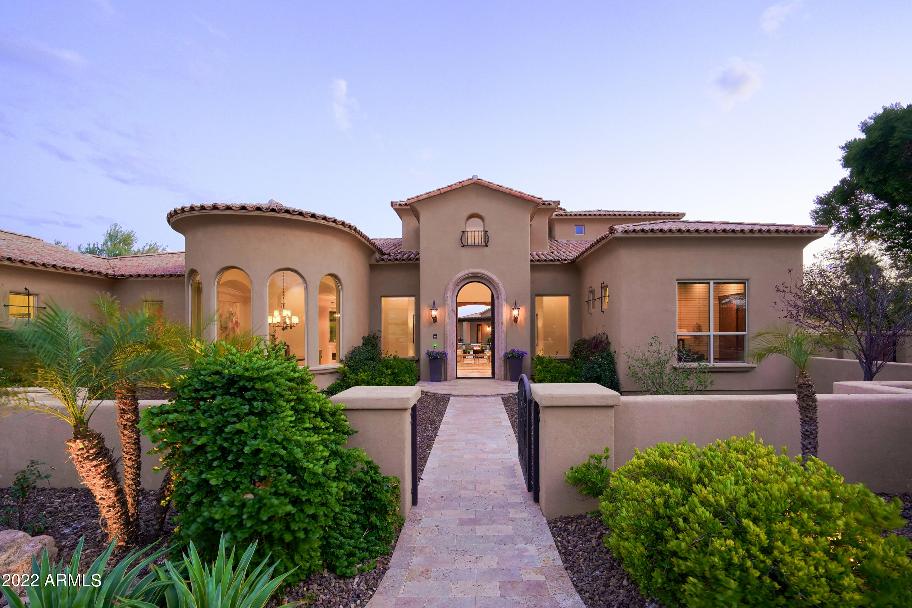 So much room to play!  This 1+ acre lot in the Cactus Corridor hosts a backyard playground for all ages with a putting green, batting cage, sand volleyball court, fire pit, sports court and a sparkling pool & spa alongside a 2 bedroom guest house.  All this in addition to the 5 bedroom north/south facing main house that has a second floor terrace to enjoy mountain & city light views. This prime location allows easy access to all things Scottsdale.  No HOA and room to build additional garage/storage for more toys/vehicles.