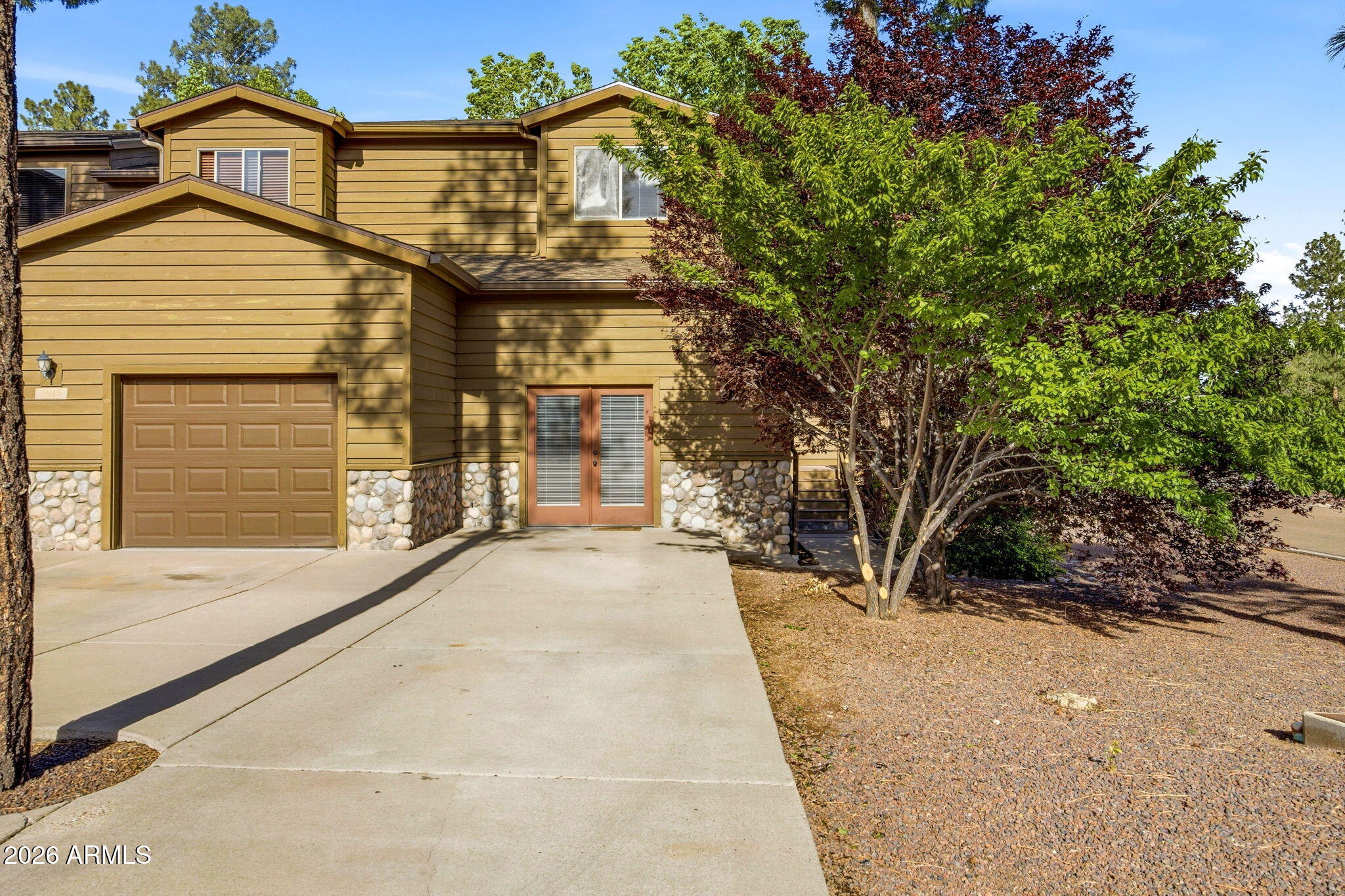 Located in the desirable Starlight Ridge community of Pinetop-Lakeside, this charming 2-bedroom, 2.5-bath with den (converted garage) townhome offers mountain living with spacious comfort and flexibility. Enjoy the cool pines from the large elevated covered back deck, perfect for relaxing or entertaining. Inside, the open-concept kitchen features an island overlooking the great room with a cozy fireplace and massive vaulted ceilings that create an airy cabin feel. Recent updates include new interior paint, new carpet, newer oven and dishwasher, updated kitchen sink and faucet, newer water heater, and replaced bathroom fixtures and angle stops throughout.
Both bedrooms are located upstairs, including the spacious primary suite with dual vanities in the primary bath. Originally a former model home, the garage has been professionally converted into additional living space measuring approximately 22' x 15', offering endless possibilities for a game room, office, or second living area -- while still allowing for an easy conversion back to a garage if desired. A fantastic opportunity to enjoy low-maintenance mountain living in the heart of the White Mountains.