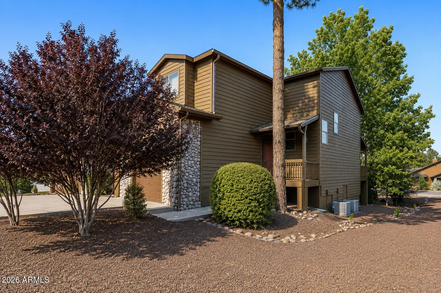 Located in the desirable Starlight Ridge community of Pinetop-Lakeside, this charming 2-bedroom, 2.5-bath with den (converted garage) townhome offers mountain living with spacious comfort and flexibility. Enjoy the cool pines from the large elevated covered back deck, perfect for relaxing or entertaining. Inside, the open-concept kitchen features an island overlooking the great room with a cozy fireplace and massive vaulted ceilings that create an airy cabin feel. Recent updates include new interior paint, new carpet, newer oven and dishwasher, updated kitchen sink and faucet, newer water heater, and replaced bathroom fixtures and angle stops throughout.
Both bedrooms are located upstairs, including the spacious primary suite with dual vanities in the primary bath. Originally a former model home, the garage has been professionally converted into additional living space measuring approximately 22' x 15', offering endless possibilities for a game room, office, or second living area -- while still allowing for an easy conversion back to a garage if desired. A fantastic opportunity to enjoy low-maintenance mountain living in the heart of the White Mountains.