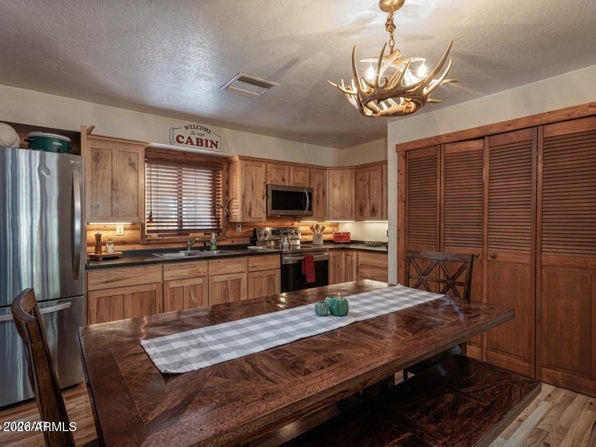 7185 Moon Creek Cir, Pinetop, AZ 85935 |
Pinetop Country Club | Rec Center Access!

Where mountain living meets effortless luxury--this fully furnished retreat in Pinetop Lakes delivers a rare combination of turnkey convenience, four-season living, and true forest seclusion.

Tucked quietly within a highly desirable pine-studded neighborhood, this home feels like a private escape the moment you arrive. Towering evergreens frame the property, and the air carries that unmistakable White Mountains calm--cool, crisp, and instantly grounding. Inside, soaring ceilings and an open-concept layout create a sense of volume and light that immediately sets the tone. The main living space is designed for connection--whether it's slow mornings with coffee, lively weekends with friends, or extended family gatherings that spill from room to room with ease.

The kitchen anchors the home with functionality and flow, keeping everyone part of the moment. Nearby living and dining spaces blend seamlessly, offering both comfort and versatility without ever feeling crowded or confined.

With multiple bedrooms and flexible sleeping arrangements, the home comfortably accommodates large groups, making it ideal for multi-generational living, hosting guests, or maximizing rental potential. Every space has been thoughtfully furnished and curated, allowing the next owner to step directly into use--no setup, no delays, no stress.

But the true heart of the property is outdoors.

Step onto the expansive covered deck and the entire pace of life shifts. Morning light filters through the pines. Evenings cool quickly into perfect mountain air. This is where time slows down--where conversations linger longer, and the outdoors becomes part of everyday living.

Located in the sought-after Pinetop Lakes community, residents enjoy access to resort-style amenities including recreation facilities, enhancing both lifestyle and long-term value. Whether used as a primary residence, seasonal getaway, or high-performing short-term rental, the flexibility here is unmatched.

This is more than a mountain home--it's a ready-made lifestyle investment in one of Arizona's most desirable four-season destinations.

Fully furnished. Thoughtfully designed. Completely ready.