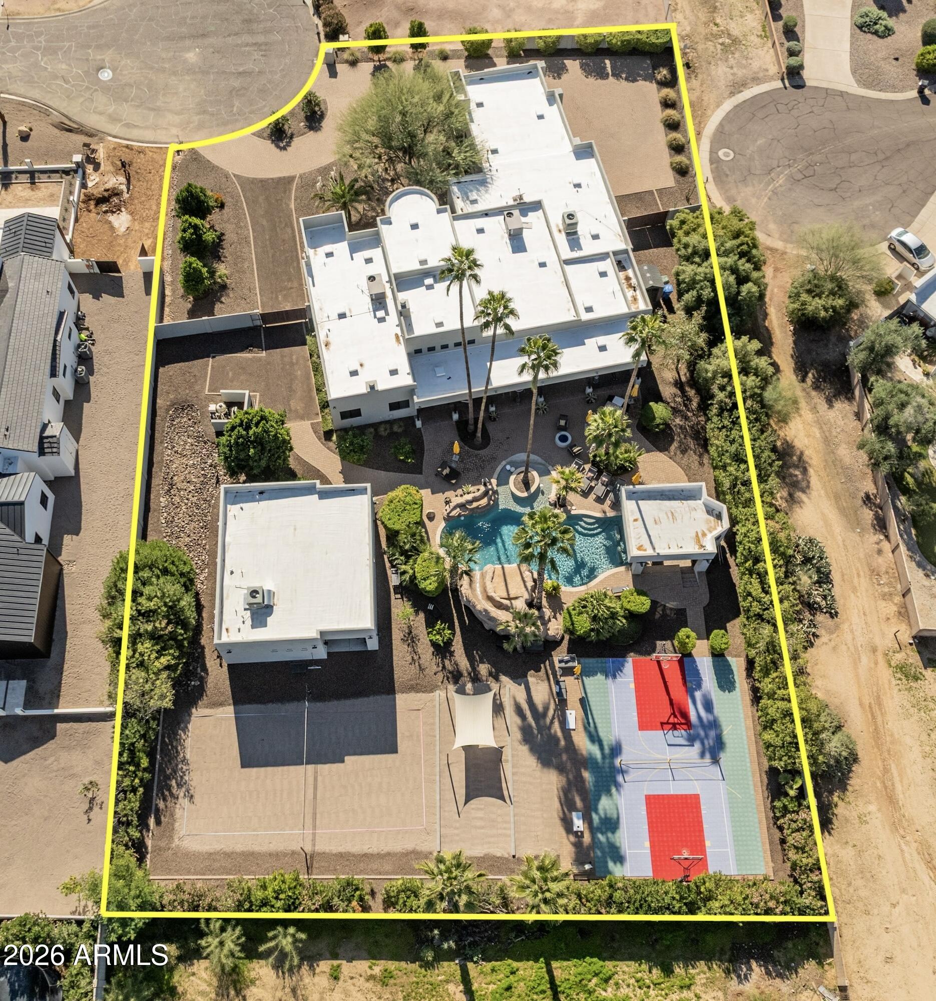 This stunning entertainer's paradise is positioned on a private & quiet north/south cul-de-sac lot in Paradise Valley's highly sought-after 3-C's school district (NO HOA). The expansive open-concept kitchen is a chef's dream, complete w/ large island, 6-burner Viking cooktop, walk-in pantry, double ovens, professional-grade refrigerator/freezer, & adjacent wet bar - making it perfect for hosting family & friends. The home also features a split floor plan, tons of natural light t/o, and finished basement w/ dedicated theatre & wine room. The backyard is off the hook with massive resort-style pool, grotto waterfall & waterslide, beach volleyball, horseshoes, cornhole, and multi-use pickleball / basketball court - It was clearly built for entertaining on a grand scale. There is also a (MORE) nearly 1,000 SQ FT detached guest casita w/ two ensuite bedrooms, kitchen, laundry, & living area. The 3-car garage offers epoxy floors, custom cabinetry, an EV charging station, and plenty of pavered parking for guests.