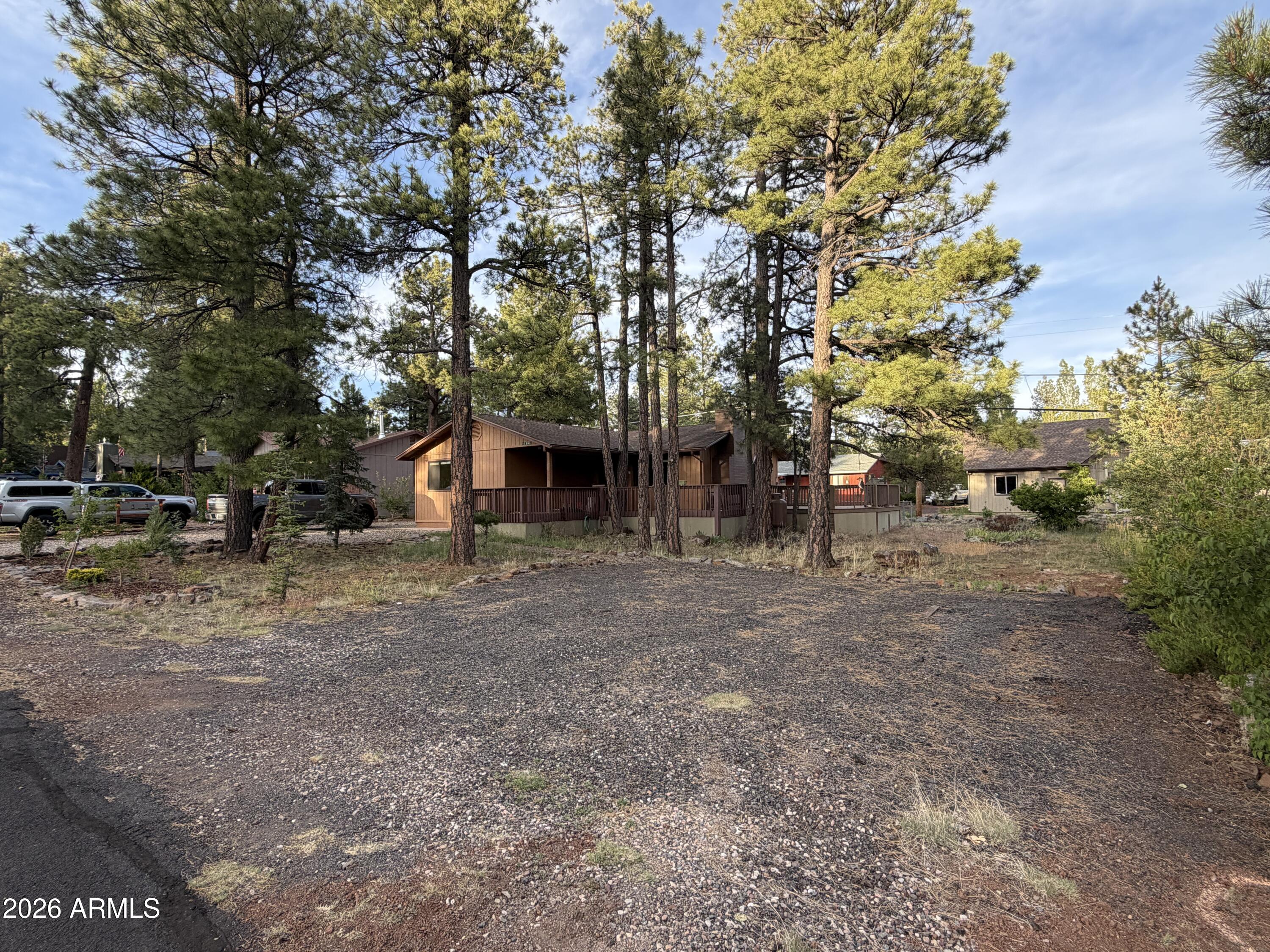 Mountain living doesn't get much easier than this. Set among the towering pines on an oversized 9,002 sq. ft. lot, this furnished cabin has been thoughtfully updated so you can spend less time working and more time enjoying everything Munds Park has to offer. The heart of the home is the completely remodeled kitchen, featuring new cabinetry, quartz countertops, and modern finishes, while both bathrooms have been beautifully renovated to match. Rare for a mountain cabin, you'll enjoy the comfort of true central heat and air conditioning with ductwork throughout the home. Outside, an enormous Trex deck creates the perfect space for summer barbecues, morning coffee, or evenings under the stars. 

Owner/Agent A detached one-car garage offers convenient storage for your vehicle, ATV, or mountain gear.

This is the kind of property where all the major updates have already been completed--simply arrive, unpack, and start enjoying mountain life.