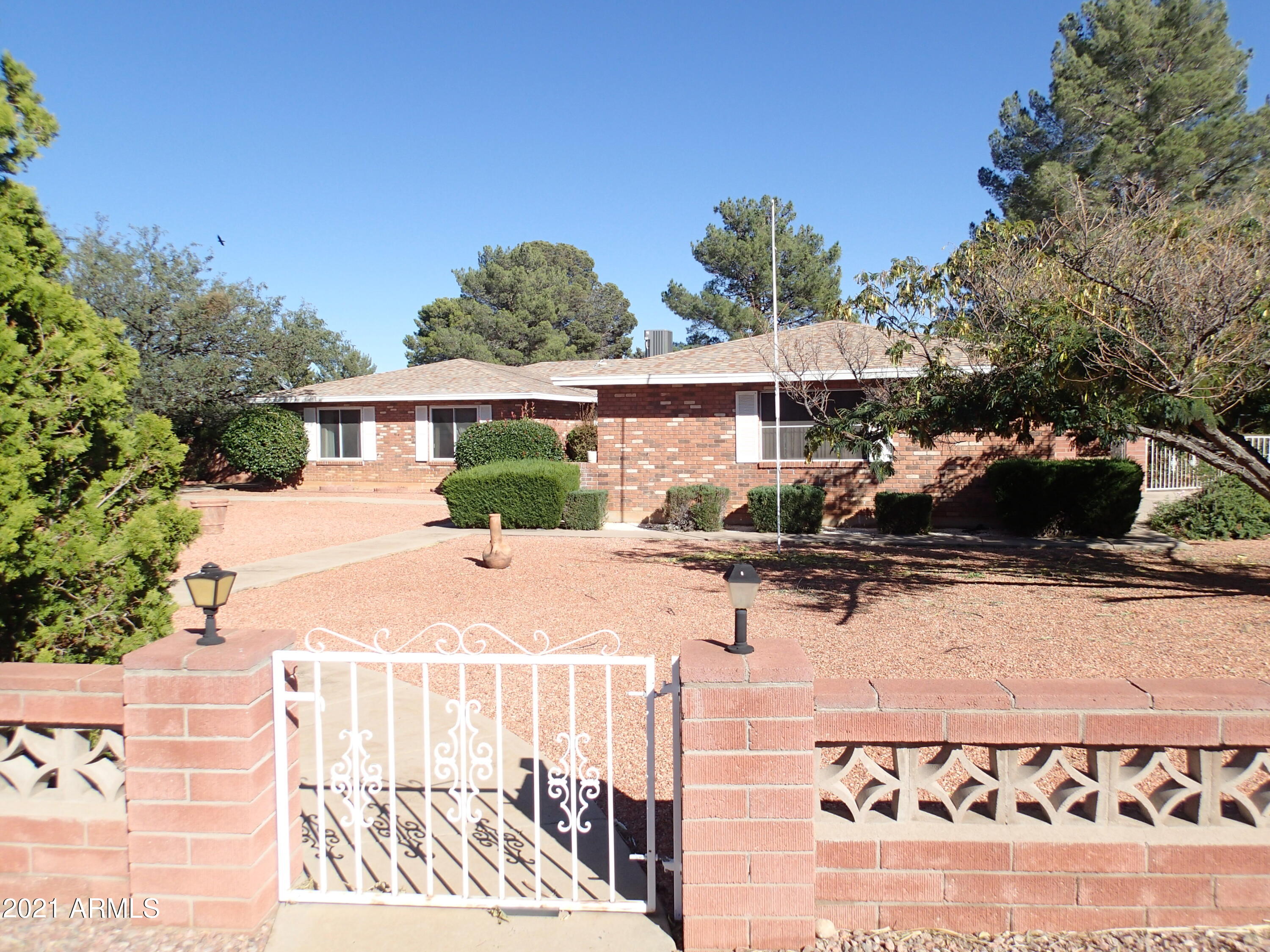 BRICK HOME ON .54 ACRE IN TOWN!!! This 1984   3Br/2.5Bath is almost 2,600sqft with Oversized Garage side entry. Full length enclosed AZ Room in back with ceiling fans. This Home has ALOT of Room to Roam.  Large Brick Fireplace in Family room, open to Kitchen with lots of cabinets, island and desk area. Vinyl Planking--Wood in Kitchen and Dining room. Home has been mostly updated with new ceiling fans, lights, bathroom sinks, faucet and plumbing.  New AC/split Furnace system installed May '18.  Nice and large room sizes. Huge Master BR has private entry out to AZ room. And, sitting bench in step in Shower. Private back yard with established trees. Workshop and a Shed. Home will have a brand New Septic Leach field by COE. This is a Must See Home of your Dreams. Won't last!!