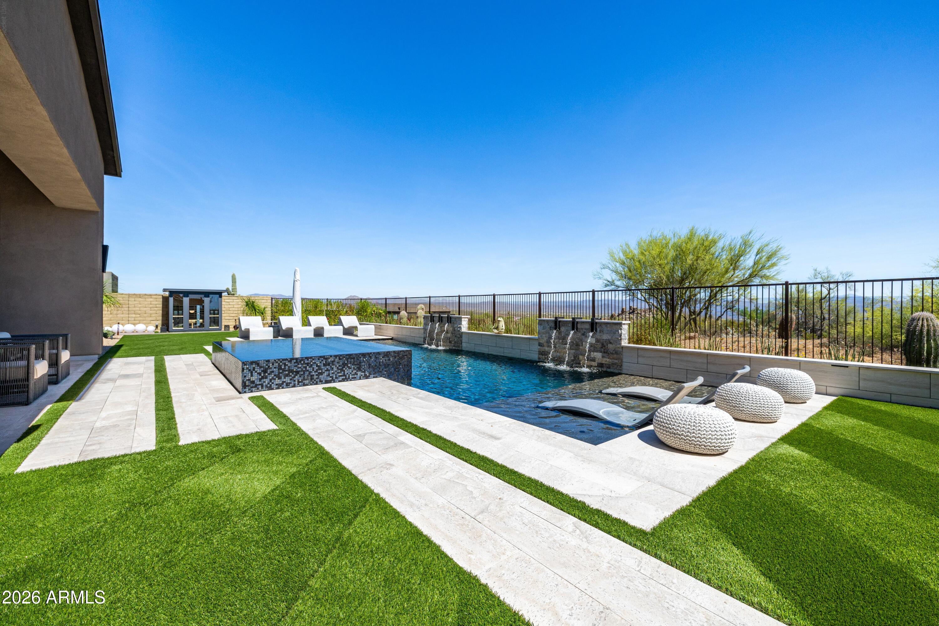 Elevate your lifestyle to new heights in this breathtaking, luxury estate nestled in prestigious Storyrock.Set against breathtaking, unobstructed mountain vistas, this elegant Rosewood Homes residence spans an impressive 5,135 square feet and features three bedrooms, a gym, and an office that converts effortlessly into a fourth bedroom.As you enter, a serene entryway courtyard and grand foyer set the tone for a sophisticated living experience. Gourmet cooking is a joy in the expansive kitchen, featuring black leathered granite countertops, a kitchen island, and Wolf appliances. The perfect blend of form and function. Additional amenities include a butler's pantry, fitness room, and an awe-inspiring office, perfect for conducting business from home. The seamless transition between indoor and outdoor living is made possible by disappearing glass walls, allowing for effortless entertaining. Outside, the pièce de résistance is the resort-style infinity edge spa and pool, complete with fountains and a pergola with fireplace. Enjoy breathtaking sun rises and serene nights under the stars. Don't miss this rare opportunity to own a piece of luxury surrounded by the Four Peaks, Tom's Thumb, Weavers Needle and McDowell Mountains in this exclusive Scottsdale gated community.