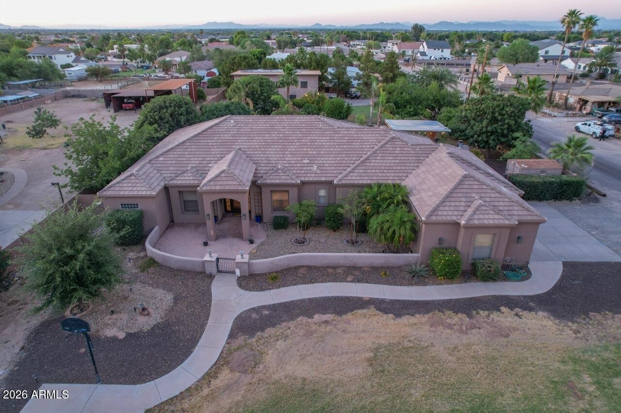 Look no further! This fantastic 4 bed, 3 bath residence in Queen Creek is the one for you! Nestled on a premium corner lot & featuring great curb appeal, a large front yard w/natural turf, and a 3 car garage plus a detached RV garage. Inside you will find formal dining & living areas w/durable tile flooring, high ceilings, a neutral palette, modern light fixtures, and a fireplace to keep you warm & cozy. The fabulous kitchen is comprised of ample cabinetry w/crown molding, granite counters, stylish backsplash, SS appliances, and a prep island. Double doors open up to the primary suite, boasting direct outdoor access, a walk-in closet, and a lavish bath w/dual sinks plus a garden tub. Lastly, your resort backyard includes a covered patio, extended pavers, a charming gazebo with hammocks to sway in w/a built-in BBQ, a sparkling blue pool with above ground spa combo! Did you see the RV garage with a bedroom loft with a bathroom/shower What are you waiting for? Don't miss out!