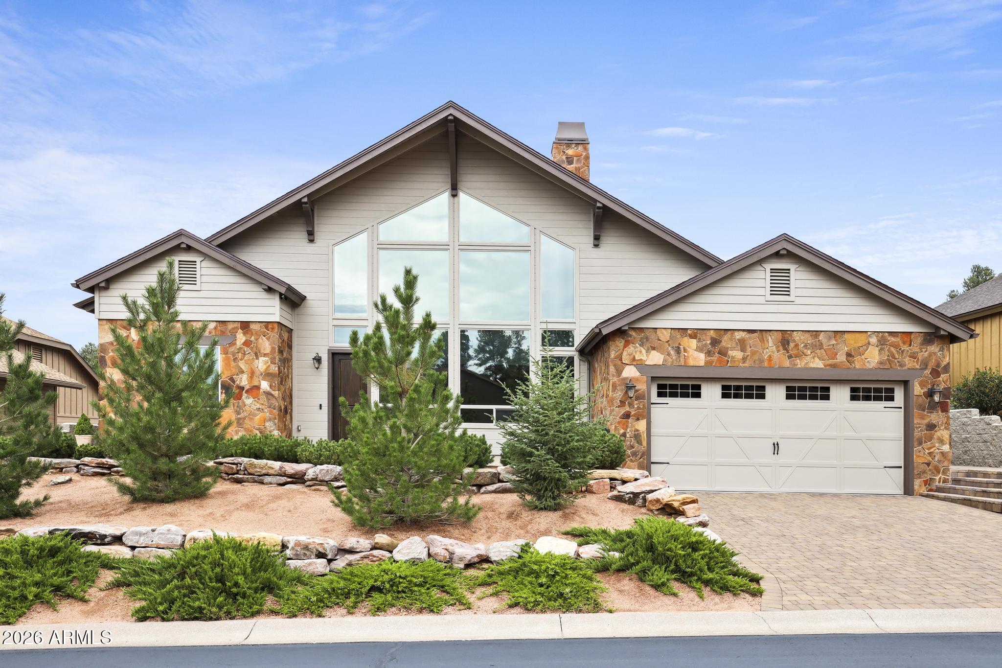 Move right in and enjoy added peace of mind in this beautifully updated chalet-inspired Payson home. The seller has completed many major improvements, including brand-new high-durability wood composite hard-surface siding, newly installed Trex decking, a roof replaced in 2024, two A/C systems installed in 2024, and a new water heater.

The home makes a striking first impression from the paver driveway, with timeless mountain architecture and a dramatic wall of windows that glows beautifully at twilight. Inside, the expansive great room is defined by soaring vaulted ceilings, rustic beams, warm wood flooring, custom window shades, and a floor-to-ceiling stacked stone gas fireplace.

A true showpiece of the main level is the open staircase leading to the loft, beautifully detailed with stone risers and a classic dark wood banister. The adjoining kitchen is both elegant and functional, featuring stone countertops, a spacious contrasting center island, rich cabinetry, a generous walk-in pantry, gas cooktop, and pot filler.

The main level offers a highly desirable split floor plan with both bedroom suites positioned on opposite sides of the home. The spacious primary suite creates a private retreat with a large walk-in closet and separate exit to the deck. The spa-inspired bath features a freestanding soaking tub set beneath a dramatic arched alcove, tiled walk-in shower, private water closet, and split double vanities with stone counters.

On the opposite side of the main floor, the guest wing is generously sized, with convenient access to a full bath just outside the door, offering comfort and privacy for family or guests.

Upstairs, the open loft overlooks the great room and is filled with natural light from the massive front windows. With its own vaulted ceiling, exposed beams, full bathroom, and slider to a private upper balcony, this flexible space works beautifully as an executive home office, media room, secondary living area, or guest retreat.

Outdoor living is effortless and low-maintenance, with multiple deck spaces overlooking mature trees and peaceful mountain surroundings. Start your mornings or end your evenings on the spacious front patio, taking in the peaceful views of the Rim and surrounding mountain landscape. 

Conveniently located near Highway 260 and just moments from the Rim Golf Club and Chaparral Pines communities, this property offers easy access to town while still enjoying the quiet beauty of mountain living. Non-resident memberships may be available nearby for golf, dining, and community amenities.