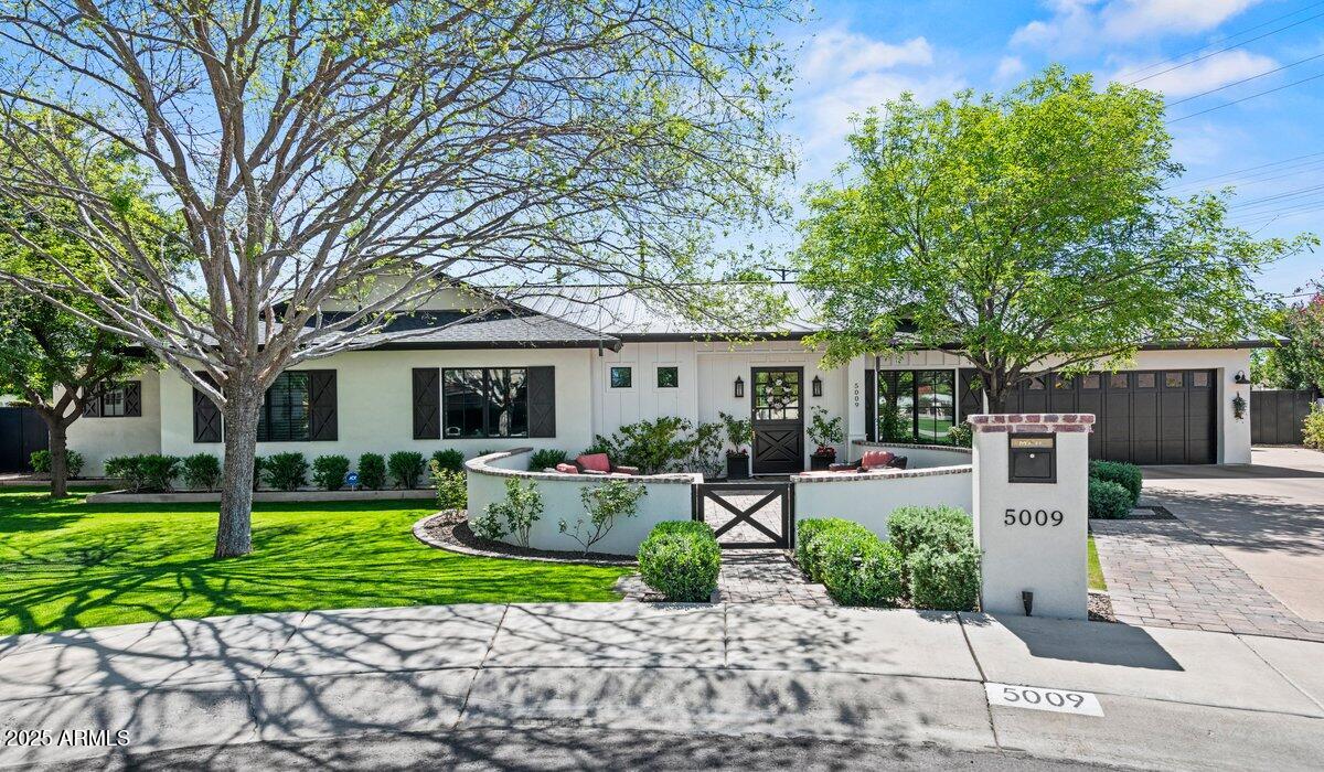 This fabulous home offers today's most desirable features, including an inviting front patio with a fire pit, a gracious open floor plan, wide-plank wood flooring, a chef's kitchen with Le Cornue range, and a great pantry. New black metal roof, black trim windows, 10' ceilings throughout, and 5B/5.5BA add to the appeal. The private and truly resort-like backyard offers a large covered patio, lush landscaping with mature trees, a beautiful pool with a ''forever swim'' feature, a large Baja lounging shelf, and multiple water features. Relax in the spa while looking at Camelback Mountain. There is plenty of room for family fun and adult entertaining. It is within walking distance to Hopi Elementary and Arcadia High School, as well as local hotspots such as The Henry and OHSO.