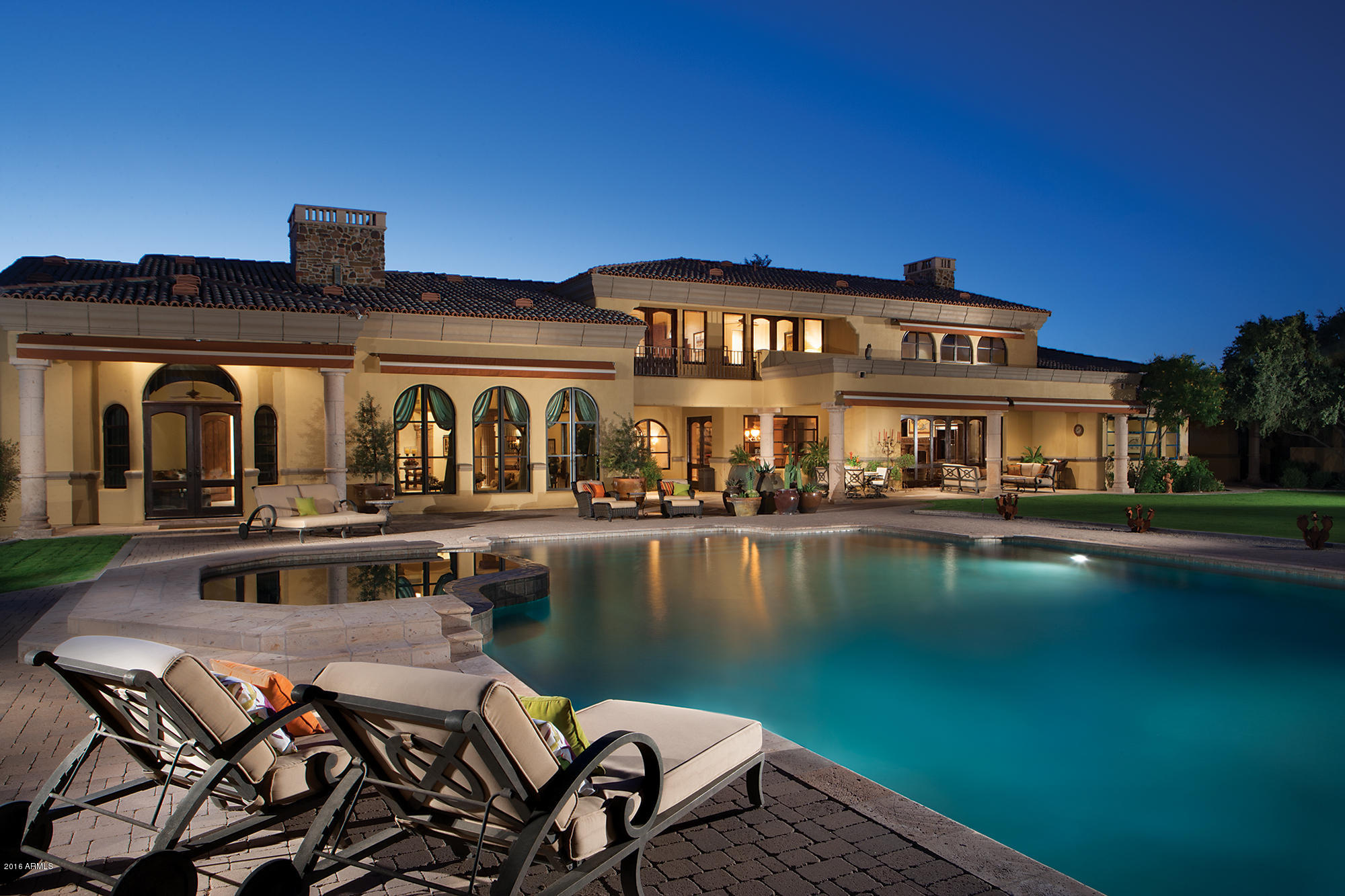 Whether relaxing by the fire in the expansive living room, or lounging outside, by the glittering pool, luxury remains the ever-present theme in this sprawling, 9,000+ square foot desert paradise. Envisioned, designed, and built by Gary Gietz, this elegant, 4.39 -acre North Scottsdale property owns marquee amenities that cater to those with more discerning tastes—artisan wood finishes, Cantera flooring, both coffered and vaulted ceilings, hand-plastered walls, and—of course—signature views of Pinnacle Peak and Troon Mountain throughout. Outside, take in the fluid motion of the water cascading through the terraced fountain, or find harmony by strolling barefoot through the grassy lawn to the capstone of the estate—a detached guest house with a 2-car show garage clad in racing-inspired red.