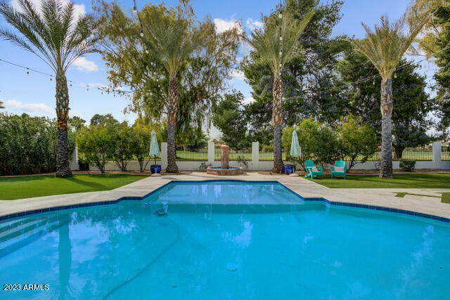 Lifestyle Is Included w/Custom New Construction. Resort Backyard sits on the 5th hole of the Orange Tree Golf.  Featured on HGTV House Hunters in 2 episodes. See Docs Tab. Indoor amenities inc Chef Style Gourmet Kitchen w/Marble Counters, Double Islands, SS Appliances, Thermador Gas Range w/Double & Steam oven. Restoration Hardware lighting, fixtures, style throughout the home. Flooring Beachwood, Travertine & Carpet in Bedrooms. Bathrooms are also focal pieces w/Powder being a one of a kind Louis Vuitton® vanity. Outdoor includes full size Living Room w/Shade Curtains under Oversized Covered Patio, TV, Dining Area, Grass Turf, Pebble Tech Sparkling Swimming Pool w/Baja Deck, Golf View, Gated Motor Court, Acre Lot, RV Gate, BBQ, Sunsets, Palm Trees, Location, Location, Location. See documents for additional information regarding HGTV House Hunters Show and List of additional features.   SPA, BBQ, and Restoration Hardware Mirrors in Living Room all convey.  Additional Golf Cart Garage not mentioned in main listing description.
