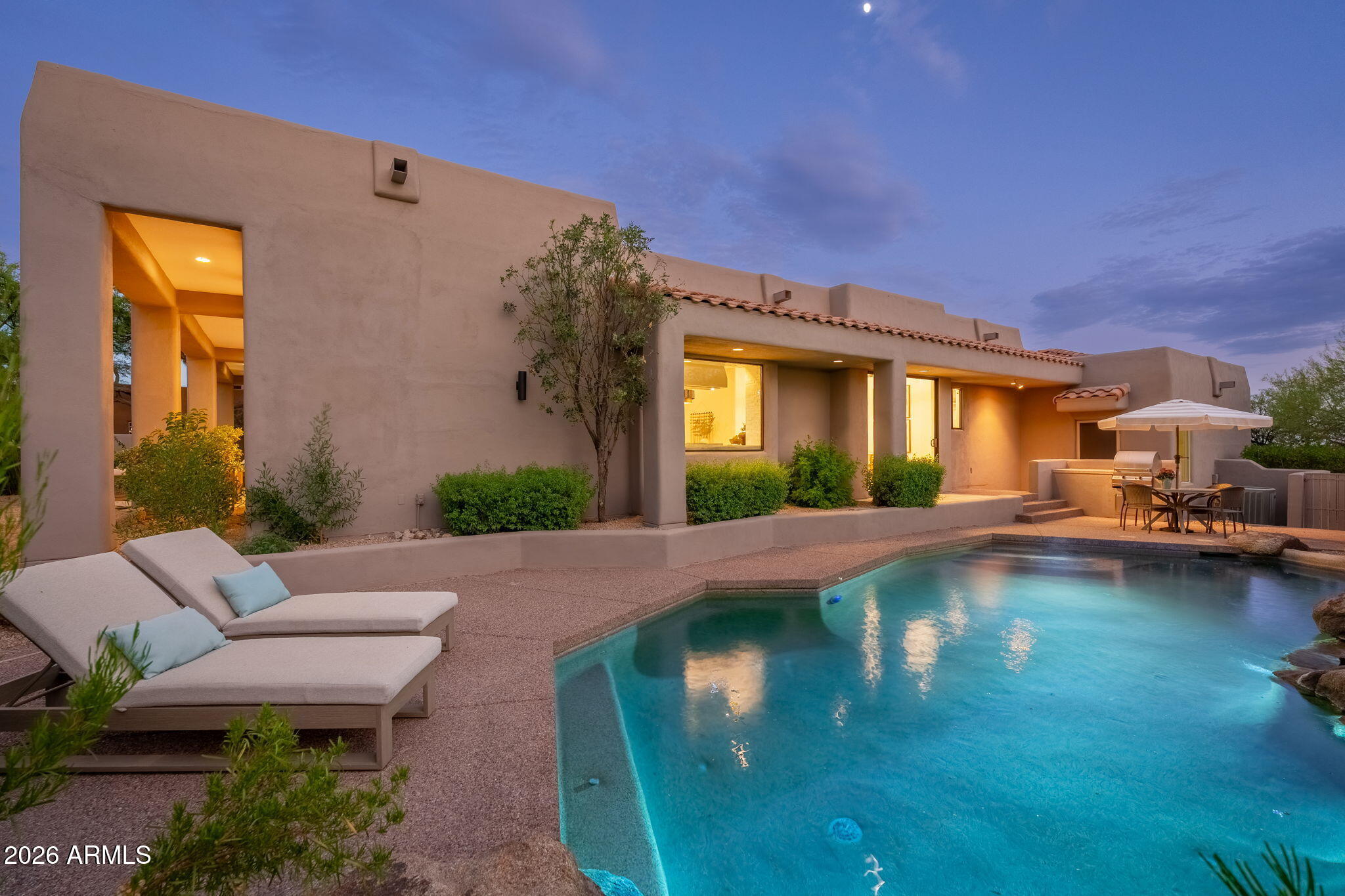Located within the prestigious guard-gated community of Candlewood Estates at Troon North, this completely reimagined residence delivers refined contemporary living against a backdrop of mountain views and unforgettable Arizona sunsets. Perfectly positioned on a premium north/south-facing corner lot, the home offers exceptional privacy while placing world-class golf, hiking, dining, and shopping just moments away. Thoughtfully remodeled from top to bottom in 2026, every finish was selected with timeless sophistication in mind. European oak hardwood flooring, oversized designer baseboards, custom lighting, new aluminum-frame windows, new doors, and a new roof with a transferable warranty create a home that is as functional as it is beautiful. Soaring ceilings, expansive windows, and an open split-bedroom floor plan fill the home with natural light while creating effortless flow for everyday living and entertaining.

At the heart of the home, the stunning chef's kitchen showcases a dramatic Taj Mahal quartzite waterfall island and matching countertops, custom cabinetry with integrated lighting, floating display shelving, a paneled refrigerator, designer range hood, 36-inch gas range, and a full-height tile backsplash. A fully equipped butler's pantry with a second dishwasher, Sub-Zero beverage refrigerator, prep sink, and abundant storage provides the perfect extension for hosting.

The great room is anchored by a striking floor-to-ceiling fireplace and opens seamlessly through an expansive accordion-style glass door to the resort-inspired backyard. Outside, enjoy multiple patios, a built-in BBQ, lush desert landscaping, and a heated pool with a boulder water feature - all perfectly positioned to capture breathtaking western sunsets.

The private primary retreat is a true sanctuary, featuring its own floor-to-ceiling tiled fireplace flanked by custom built-ins, dual custom walk-in closets, and direct access to the backyard. The spa-inspired bath rivals a luxury resort with a spectacular wet room featuring a steam shower, freestanding soaking tub, marble flooring, dual vanities, custom cabinetry, and integrated toe-kick lighting.

Three additional bedrooms occupy a separate wing of the home, including a private ensuite ideal for guests. Designer bathrooms, premium finishes, a mudroom with built-in storage, and a sophisticated powder room complete this exceptionally functional floor plan.

Residents of Candlewood Estates enjoy the security of a guard-gated community along with convenient access to Troon North Community Park, championship golf, hiking trails, tennis, and all the amenities that make North Scottsdale one of Arizona's most coveted luxury destinations. This is turnkey desert living at its finest.