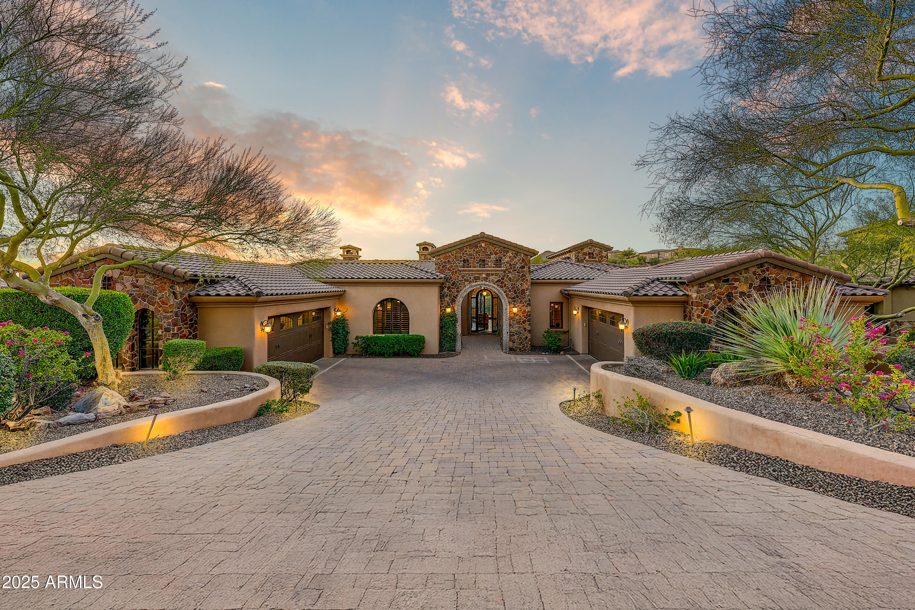 Enjoy massive golf course views from this meticulous FireRock Country Club estate. This property lives like a single level home with all major rooms on the first floor entry level. Pass the tranquil courtyard and immediately notice motorized walls of glass showcasing the emerald Golf Course beyond. An open great room is enhanced with soaring ceilings, impeccable carved carpentry, and stunning planked flooring. Open to the great room, the chef's kitchen will inspire culinary delight with dual sub-zero refrigerators, dual oven range, dinette, custom stone details and a contrasting island with tiered barstool seating. Just off the 481 bottle wine cellar, the formal dining is lined with windows and covered with fantastic arched ceilings. Relax with your favorite glass of wine while enjoying multiple terraces and patios. Compelling rejuvenation, the master retreat is complete with its own foyer, two way fireplace, private patio access, blackout shades, dual vanities, oversized jetted tub, separate stone shower, and massive walk-in closet. An additional en-suite bedroom, laundry, and incredible office with courtyard access complete the main level. Perfect for guests or family, the downstairs features three additional en-suite bedrooms, tiered movie theatre, large family room with kitchenette and an additional washer and dryer . Designed for the ultimate experience during any Sonoran season, the backyard is a true oasis with multiple open air and covered patios, a sparkling negative edge pool, bubbling spillover spa, built-in misting system, lush foliage, and more emerald views. Car enthusiasts will appreciate the two oversized and over height garages that allow for both low profile and XL sized vehicles. Additional features include a hassle free synthetic stucco exterior , multiple refrigerators, indoor/outdoor sound system, engineered elevator shaft, and much much more