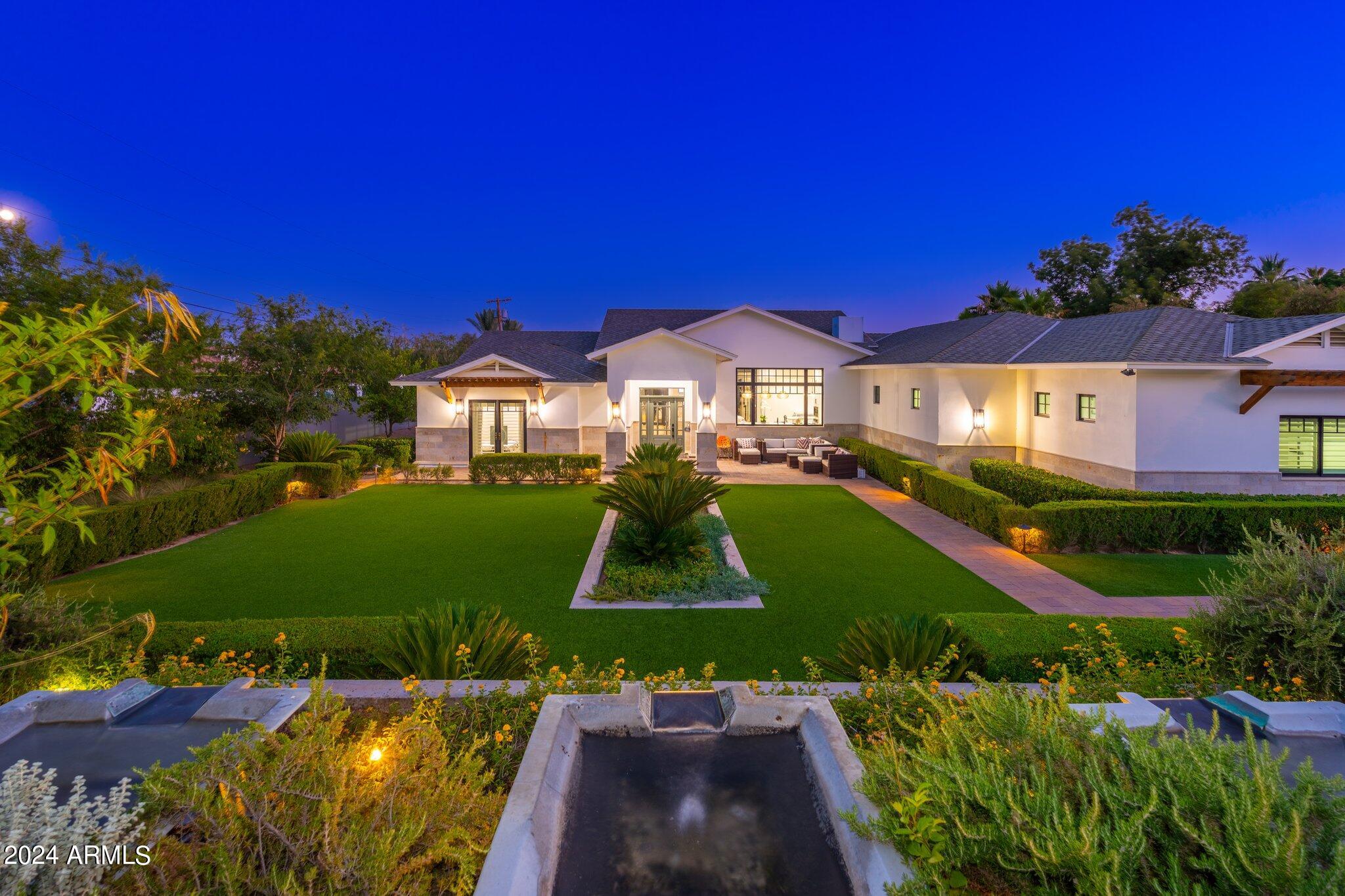 Welcome to an exquisite estate nestled in the heart of Phoenix's prestigious Arcadia neighborhood. This luxurious residence offers an unparalleled blend of elegance, comfort, and modern amenities, making it the perfect retreat for discerning buyers. Ideally situated at the base of Camelback Mountain, this property boasts breathtaking mountain views and provides direct secured ally access to Arcadia's hiking trails, walking paths and bicycle rides. This expansive home features 5 spacious bedrooms and 5 elegantly designed bathrooms, ensuring ample space for family and guests. The open-concept floor plan with 3643 sqft in the main house includes a grand living room with soaring 12ft ceilings and cozy fireplace, a formal dining area, stunning hardwood floor, and a 685 sqft fully equipped kitchen in the guest house with a huge steam shower all designed for seamless entertaining. The gourmet kitchen is a chef's dream, complete with high-end Wolf and Viking stainless steel appliances, custom cabinetry, a large center island, and stunning porcelain countertops. The luxurious master suite is a private oasis featuring a spa-like ensuite bathroom with a soaking tub, a separate shower, dual vanities, and a huge walk-in closet. Step outside to your private backyard paradise, featuring a sparkling pool & spa, a covered patio with an outdoor kitchen, and meticulously landscaped grounds, perfect for relaxation and entertaining. This home also includes a home office/den, 3-car garage, RV Parking, security gate with intercom system, all TV appliances and state-of-the-art smart home technology for modern convenience and security. Experience the epitome of luxury living, where every detail has been thoughtfully crafted to offer the ultimate in comfort and style. Come and discover all that this remarkable property has to offer.