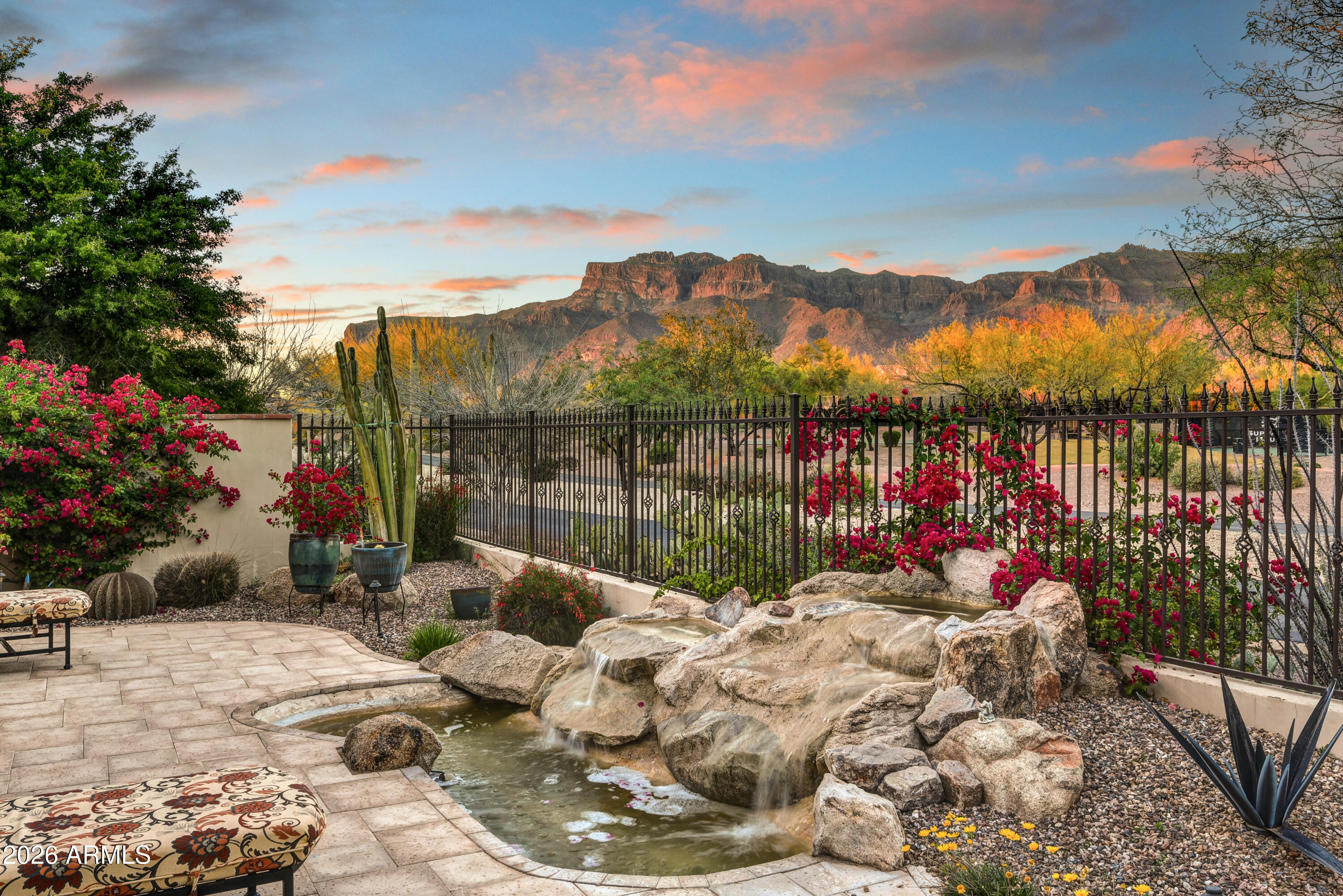 OFFERED FURNISHED! EXCEPTIONAL OFFERING! REMODELED & UPDATED. COVETED FIRST WATER VILLAGE. WONDERFUL BACK PATIO SUPERSTITION MOUNTAIN VIEWS. A LYLE ANDERSON COMMUNITY w/24/7 guard gate. 36-HOLES NICKLAUS DESIGNED GOLF in quiet Gold Canyon only 35 minutes from Sky Harbor & 20 minutes to Mesa Gateway. LOCK & LEAVE! Club membership-separate agreement. Short walk to fitness center, tennis & pickle ball, heated lap pool. High end upgrades t/o. New interior lighter paint, new wood grain tile flooring w/one room exception. Existing granite plus new quartz counters. 3 beds/3 bath, split plan. Office/den w/bath. Kitchen granite w/4-seat island, eat-in kitchen, SubZero frig, Dacor gas stove. All cabinets new paint. New D/W & micro. Open great room/kitchen layout/dining area to spacious patio w/built-in BBQ and waterfall feature. Attractive kitchen backsplash. Newer furniture. All internal plumbing/piping replaced, changed faucets in all baths, new water heater, new whole house water softening, and added water purifier under kitchen sink, replaced all toilets. All wall switches changed to match the re-painting. No carpet--all easy care flooring t/o. Office with Murphy bed. Primary bath W/new double sinks and added quartz countertops, private water closet. Primary closet with incredible build-out. Solid core interior doors w/Emtec hardware, surround sound, beamed ceilings. New outdoor irrigation system, landscape rock, and numerous added cacti plantings. 2 private patios, 3 fountains. New garage door opener. Quiet streets, cul de sac, low traffic. Only 36 hole true private golf and country club in central Arizona. Restricted membership offers members low ratio of golfers to number of courses and uncrowded conditions. Only one traffic light separates residents from the Atlantic and Pacific Oceans.  Where Else? Nowhere else but here!