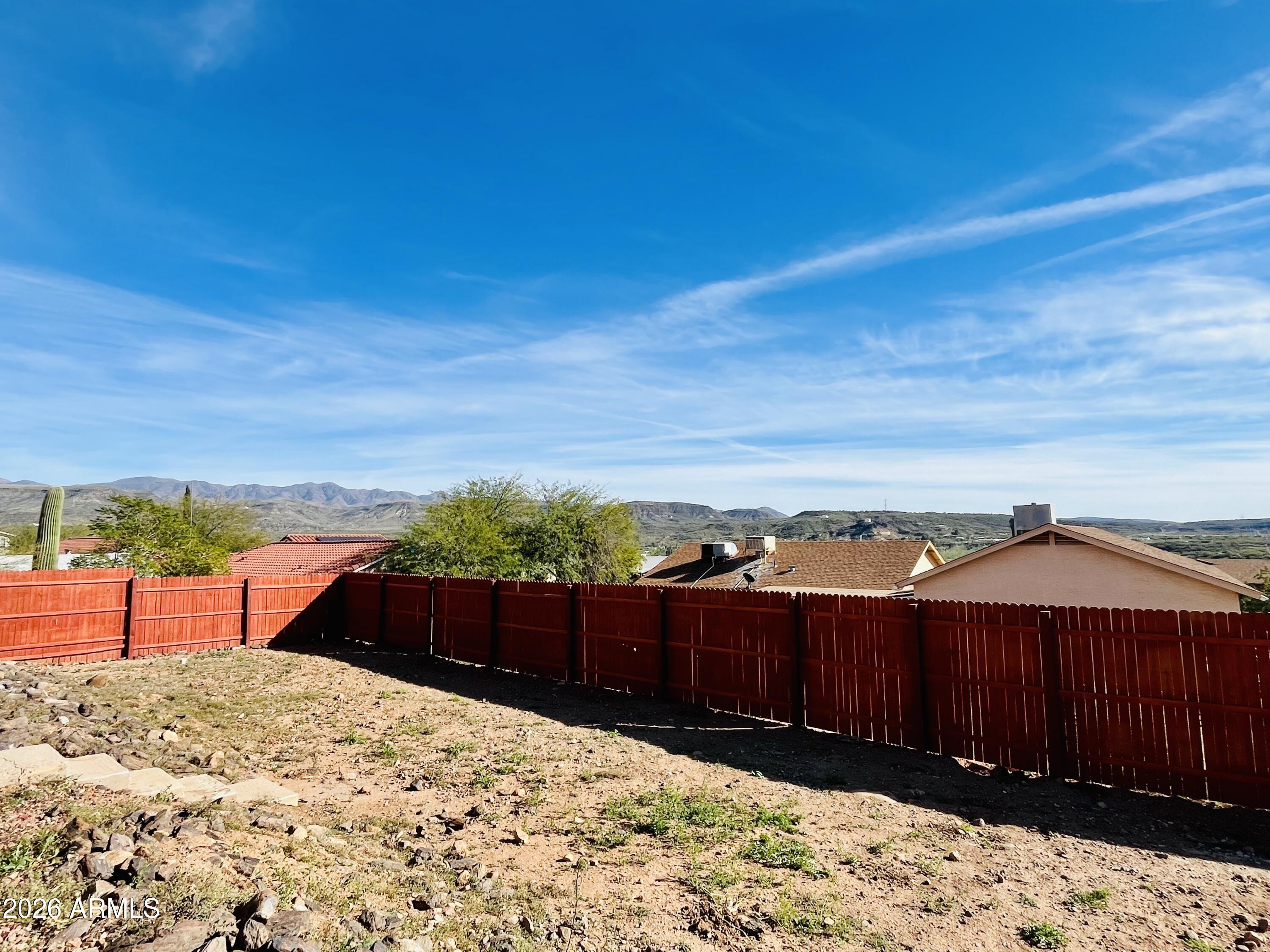 This hillside retreat sits above neighboring homes and takes full advantage of fantastic mountain views from the front porch. Enjoy peaceful high desert living with easy I-17 access for a quick commute to Phoenix or Prescott. Inside, you'll find a comfortable, functional layout with bright living spaces and room to relax or entertain. A spacious two-car garage plus an additional garage-door space are ideal for a workshop, workout room, studio, or private getaway. Unlike many area homes, this property is served by a reliable local water company--no well to worry about. Your own slice of Arizona with space, privacy, views, and convenience. Qualifies for USDA loan with no down.  Check with your lender The kitchen cabinets are bright but a fresh coat of paint can change the look to fit your tastes.