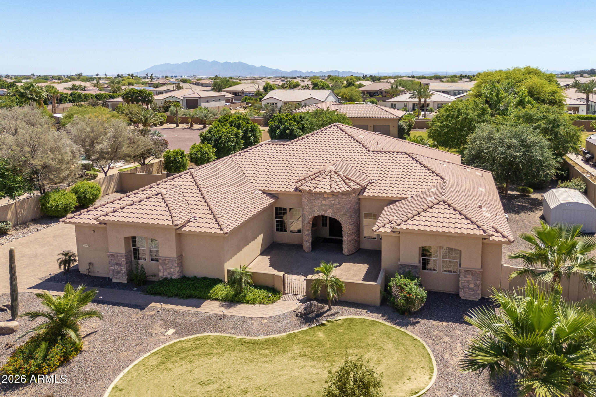 Highly sought after acre lot homes in gated community!  Rare oversized detached garage/shop with AC, large RV parking bay and multi car bay with lift.  Perfect living and entertaining layout with open great room floor plan, dramatic elevated ceilings, custom naughty alder cabinets, large kitchen island with extra storage, built in Viking stainless appliances, large gas cooktop, travertine tile, wood flooring, custom built ins, spa like master bathroom with snail shower and jacuzzi tub, guest suite with bathroom and living area at the front of the home with its own entrance from the front patio, paver extended back patio with outdoor kitchen, pool, grass, mature trees, north/south exposure, this home is a must see!