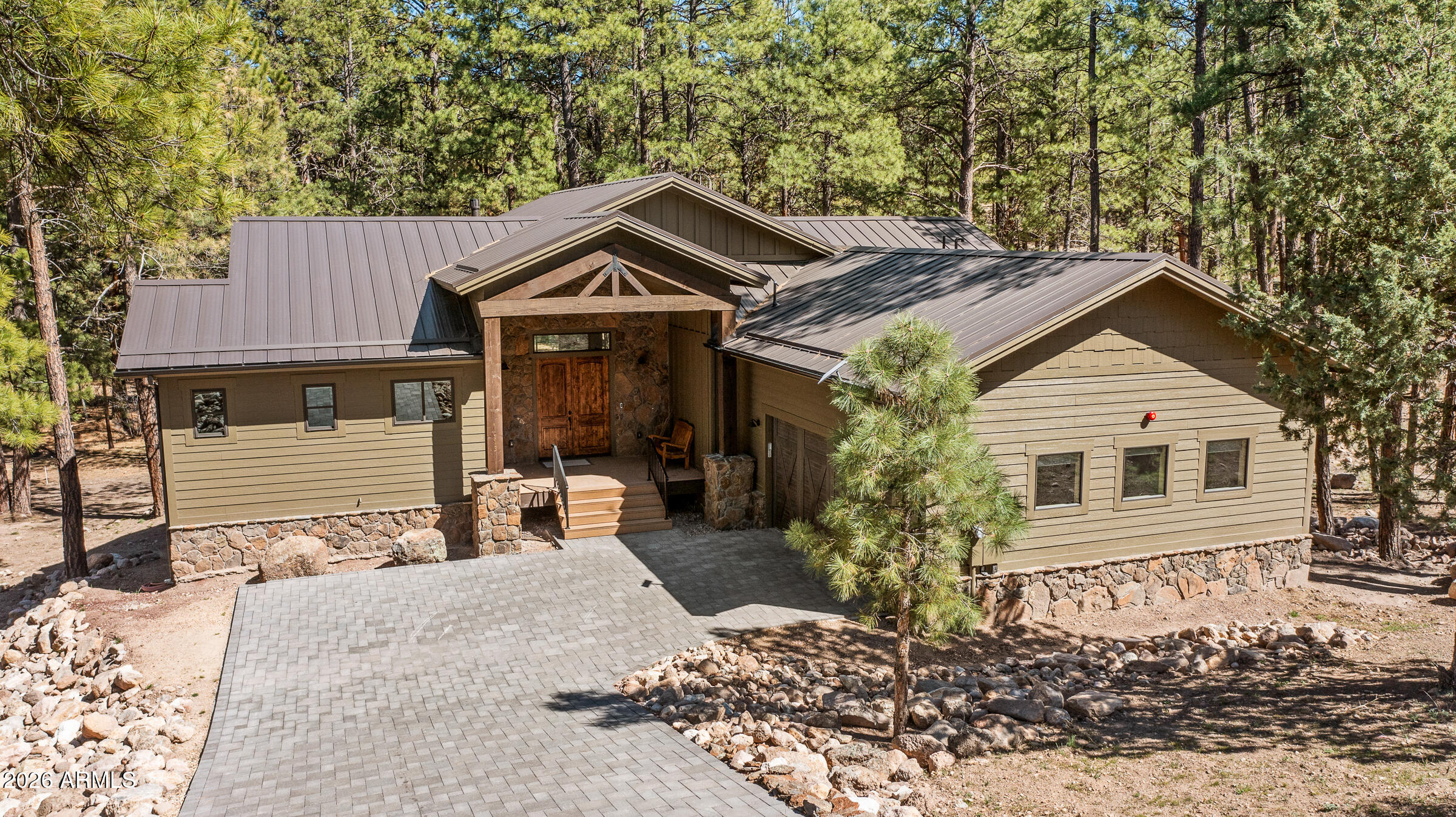 Newly built custom mountain estate in the gated community of Escalante, offered fully turn-key and move-in ready. Designed with a seamless open floorplan, the main level features a spacious primary suite alongside two guest suites. A dramatic wall of windows and soaring vaulted ceilings frame picturesque views of towering Ponderosa pines, bringing the outdoors in.
The home is exceptionally well-appointed with dual full kitchens, perfect for entertaining or multi-generational living, featuring soft-close cabinetry, Samsung and GE appliances, a gas range, and a walk-in pantry. The primary suite offers a true spa-like retreat with an oversized walk-in shower and a freestanding soaking tub elegantly set within a glass and tile surround. Luxury vinyl plank flooring runs throughout, complemented by a main-level laundry room with direct access to the two-car garage. Step outside to an expansive elevated Trex deck, ideal for enjoying the peaceful forest setting.
The lower level expands the living space with a secondary full kitchen, generous family room, additional en-suite guest bedroom with a walk-in glass shower, a second laundry area with Samsung washer and dryer, and a versatile bonus room perfect for bunk beds, a game room, craft space, or extra storage. A walk-out patio and paver driveway complete the property.
Additional features include Starlink satellite internet, ensuring reliable connectivity in this serene mountain setting.