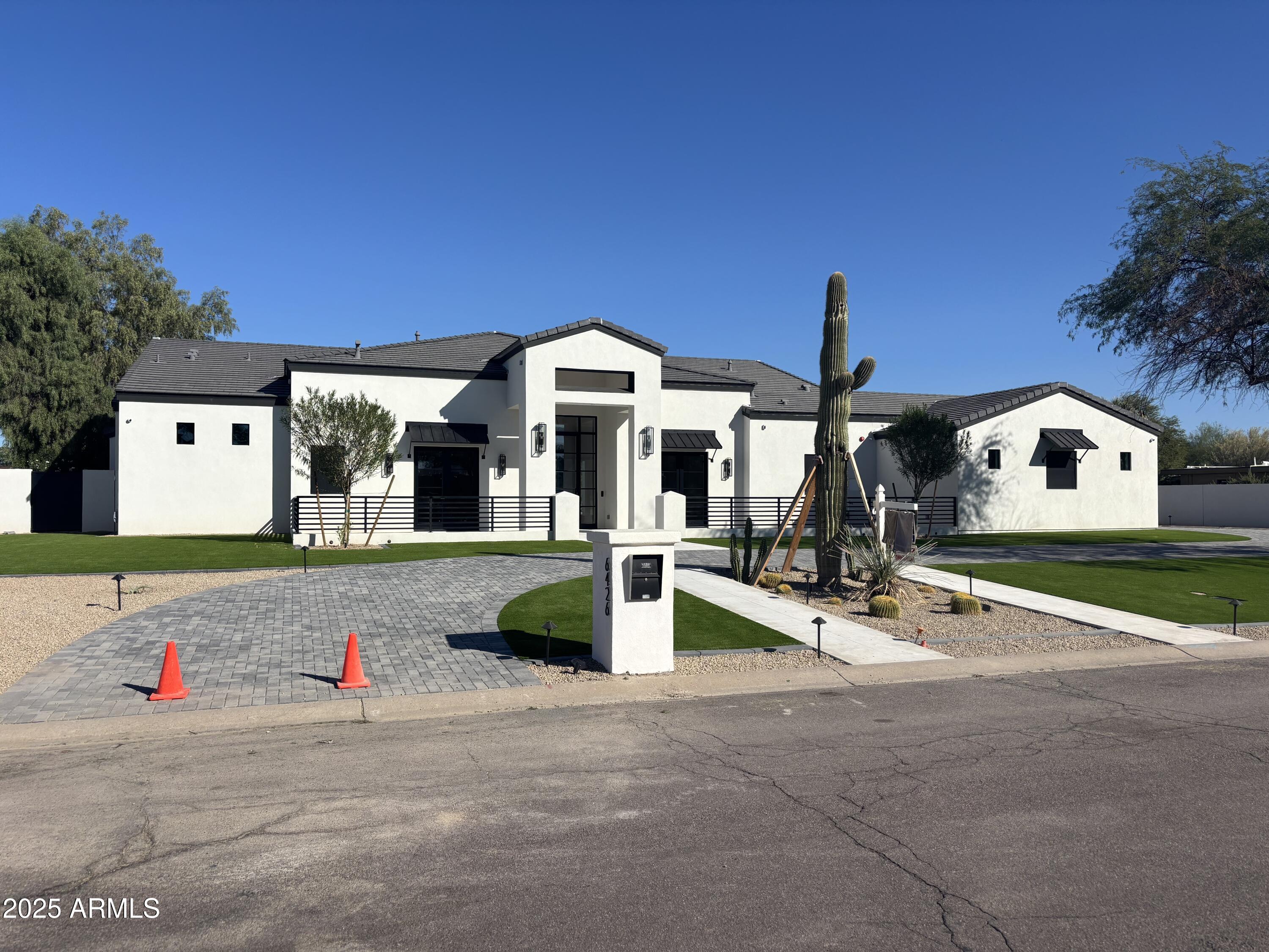 NEW! Brand new transitional style custom home w/ Control 4 automation system --6 bedroom/6.5 baths/+ a sep. game room (in the secondary wing) & a flex room in the primary suite! Soaring high ceilings throughout this fabulous home w/ a light, bright & airy open floor plan featuring a 26 ft wide/10 ft. high retractable wall of glass doors in the great room!  Custom cabinetry through-out this custom home ---& a dream chef's kitchen boasting over the top Sub-Zero/Wolf appliance pkg including a separate Sub-Zero refrigerator & freezer/4 Wolf ovens/ & 2 Cove dishwashers! Palatial primary suite w/ 15 ft. high ceiling + flex room & spa-like primary bathroom w/ sep. HIS/HER vanities & sep. HIS/HER walk-in closets & lg. walk-in shower w/ dual glass door entrances! All secondary bedrooms are ensuite Game room in the secondary wing of the home.  Sierra Pacific window/door pkg. in this custom home! French oak wood flooring throughout the home! Huge backyard w/ lg. showy pebble tech pool/spa w/ deck jets & fire/& water features!!  Quiet tucked away location---in this quiet tucked away neighborhood in the highly desired 3 C's school district of Paradise Valley! Epoxy garage floor finishing! Move in ready 10/1/25! This quiet, tucked away Paradise Valley neighborhood is "in transition" w/ 4 other brand-new homes being built in the next 12 months besides this new custom home!!
