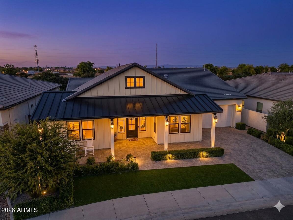 The modern Farmhouse ''St Helena'' model next to the Clubhouse and on HOLE #8... is worth every second of your time to tour it. NOTHING has been left untouched (tastefully done upgrades throughout). From the front porch, to the back of the home, this property has it all, boasting: Iron door with glass panel that opens, all 3 bedrooms are separated and at other ends of the house, MASSIVE built in fridge, cabinet upgrades throughout, media wall in living room, extended shower in Primary bedroom, dedicated office, garage with tons of style (& epoxy), 16 ft multi-panel collapsing slider that CREATES THE INDOOR OUTDOOR FEEL of the floor plan. Bonus: Built-in bbq, extended covered patio, gas fire pit, and the coolest pizza oven you've ever seen... & a complete wrap of Trimlight holiday lights.