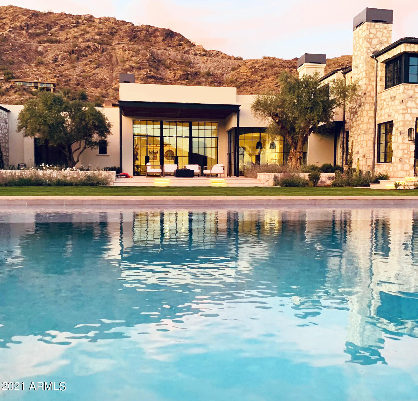 The poetry of passionate minds created the artistic ambiance of an old stone coastal farmhouse blended with  modern contemporary architecture.  The iconic view of Camelback Mountain became the inspired vision which produced this organic architectural experience on Mummy Mountain in 2020.  Mixing authentic materials in intimate spaces bathed in natural light gave birth to a luxurious minimalism on this fabulous site.  Elements of soft, hand plastered walls, steel framed windows & doors, reclaimed wood beams, imported Belgian Bluestone & French Oak floors combine to offer relaxed, low key luxury in an artisan crafted balance between what feels ageless, but is actually brand new.
~BOHEMY HOUZ  INTERIOR DESIGN STUDIO ~ MATT THOMAS, ARCHITECT ~ BERGHOFF LANDSCAPE DESIGN