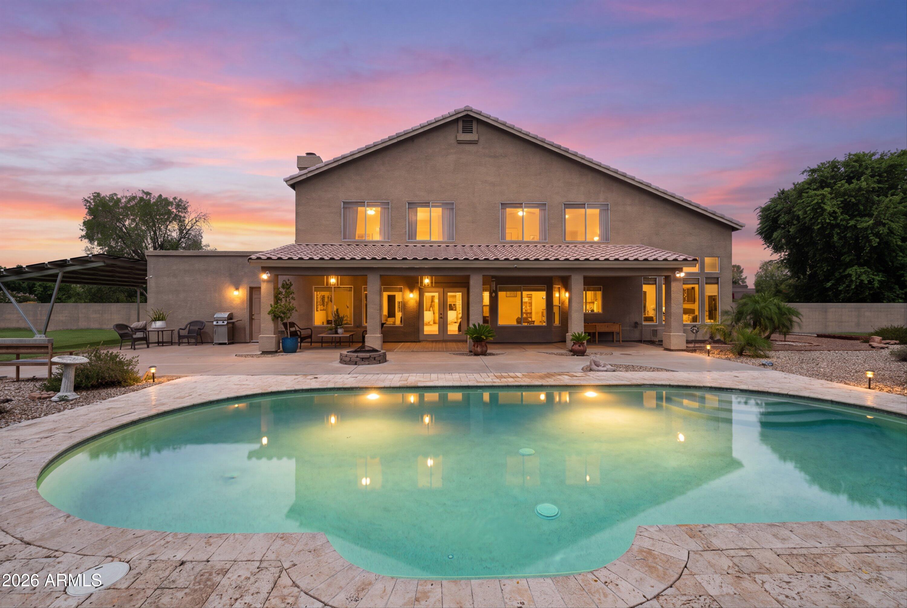 Set within one of Gilbert's most exclusive equestrian neighborhoods, this exceptional estate offers a rare opportunity to own over an acre of irrigated land with horse privileges in an unparalleled location. Thoughtfully designed with 5 bedrooms, 3.5 bathrooms, attached casita, resort-style pool, and a 3-car garage, this property seamlessly blends luxury, privacy, and versatility. Walls of windows fill the home with natural light while framing the lush backyard. The chef's kitchen is the heart of the home, featuring a large center island, custom cabinetry, SS appliances, and a walk-in pantry, all opening to the inviting family room with a fireplace and wet bar. A main-level secondary primary suite, currently used as an office adds flexibility for guests or multigenerational living. Upstairs, you'll find three spacious bedrooms, an expansive bonus room ideal for a media or game room, and a luxurious primary retreat with dual vanities and a walk-in shower. The detached casita is fully self-contained with its own kitchen, living room, bedroom, private entrance, and endless possibilities for guests or extended family.

Additional highlights include flood irrigation, RV gates with a 60-foot parking pad, and 36 owned 10kW solar panels. Opportunities to own an estate of this caliber in one of Gilbert's most coveted neighborhoods are few and far between.