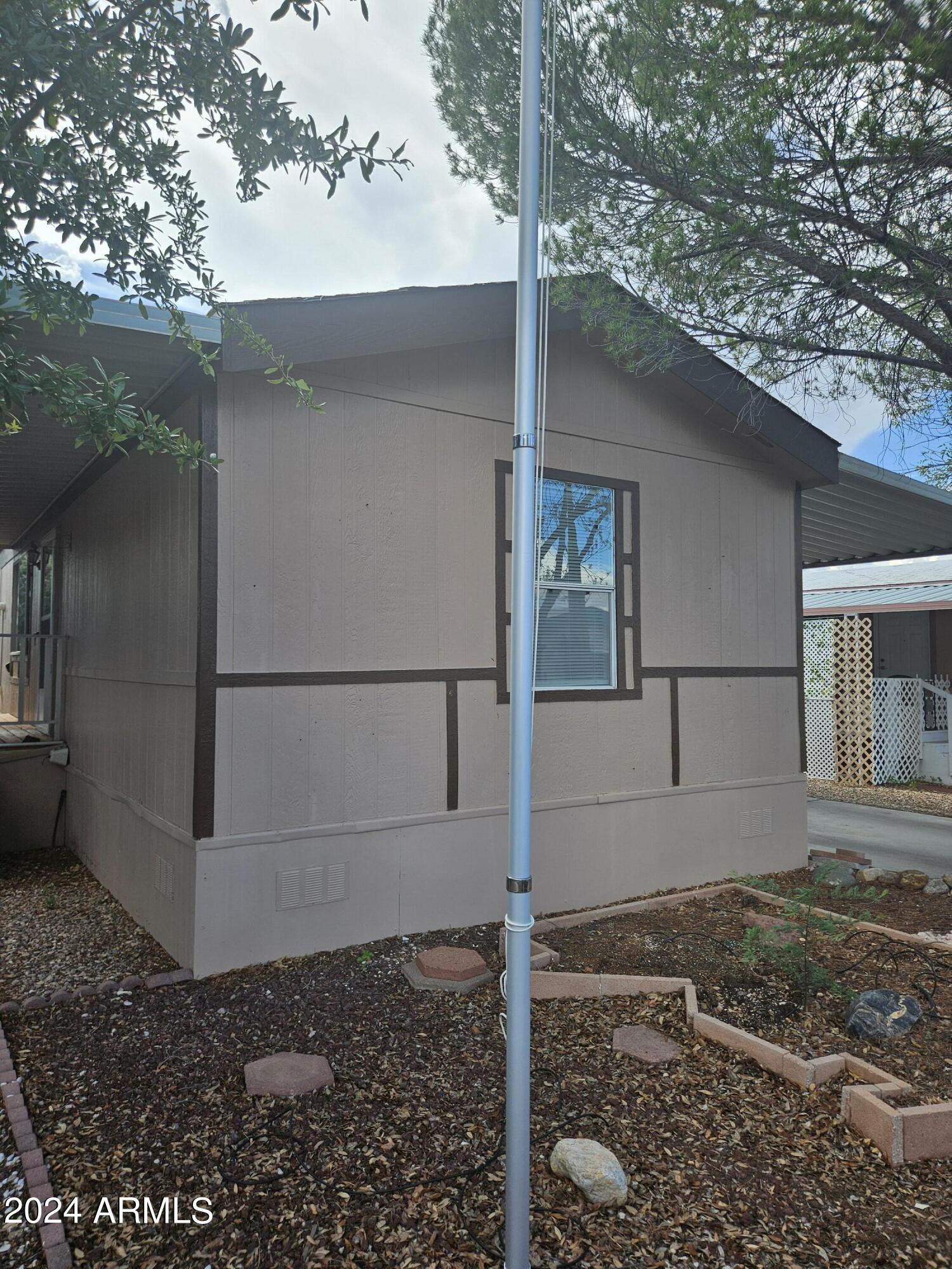 2 bedroom, 2 bath home offering 1,120 square feet of living space. Split bedroom plan. Front covered patio with wood deck. Wood fence around side yard of home offers a wonderful private area to enjoy being outside. Back yard offers a screened in patio area. Home also includes a shed on the property. Home is located in a gated community with two clubhouses. An indoor pool and spa are located at the larger club house and an outdoor pool is located at the smaller of the two club houses. Home sold AS IS.