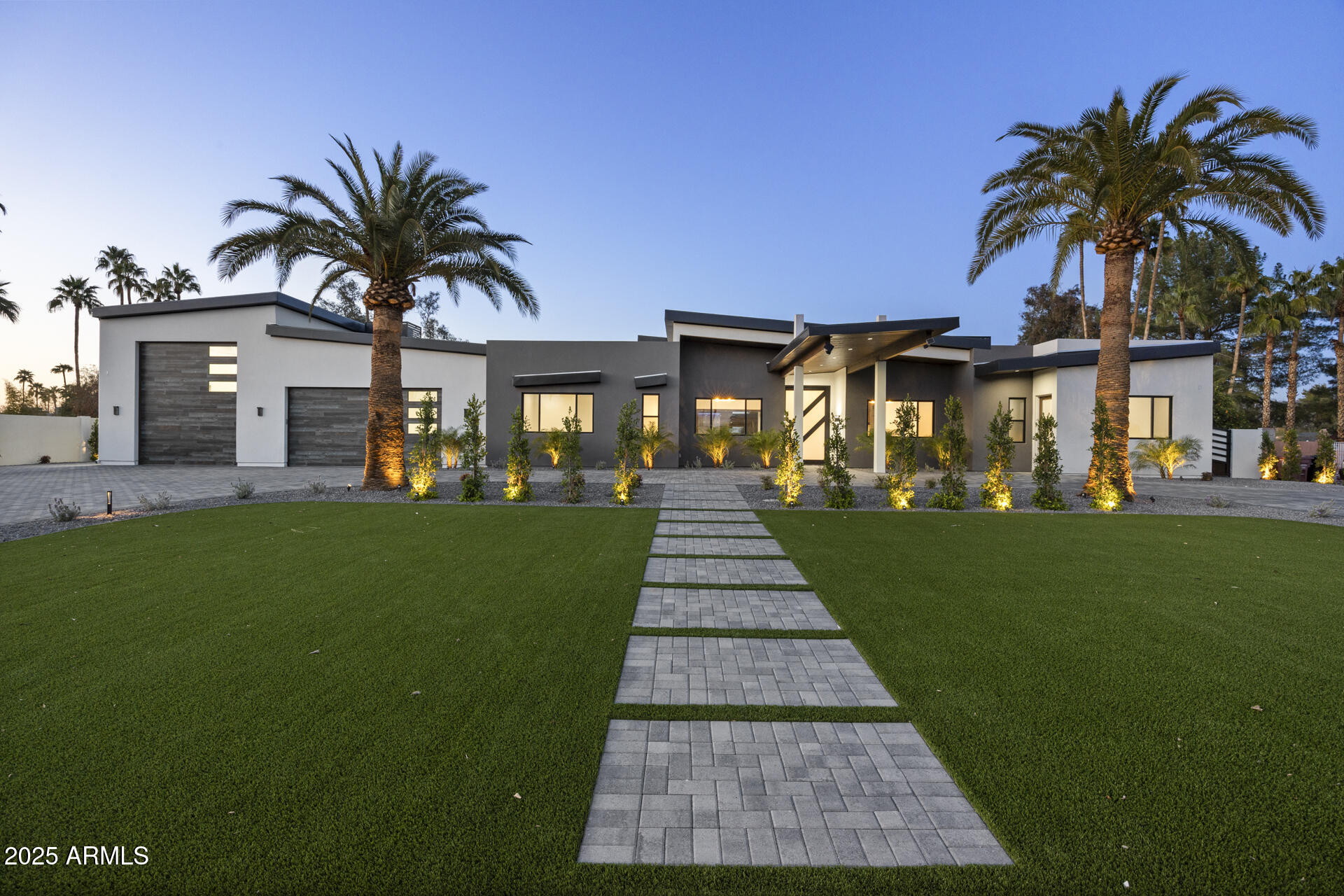 STUNNING, new construction where modern elegance meets thoughtful design. Nestled in the highly desirable Cactus Corridor, you are welcomed into this pristine, 5,957 sqft estate with a custom, oversized door. Featuring 6 spacious bedrooms, each complete with custom walk-in closets, 7.5 tranquil bathrooms, and endless high-end luxury finishings. Premium engineered European oak hardwood floors, and Furgeson light fixtures spanning throughout the home. Incorporated into the living area is a Napolean 72'' gas fireplace, surrounded by built in cabinetry with recessed lighting. The Gourmet chef's kitchen is equipped with superior stained oak cabinets, an expansive island, Calacatta Doria countertops, a gas 48'' wolf stovetop, Butler's pantry, and a wet bar. ...continued in more. The primary bedroom boasts a massive his and hers walk in closet, incorporating more recessed lighting throughout, a dual walk-through shower, and a woodbridge freestanding tub. Additionally, an en-suite Casita has its own private entrance, perfect for guests or a private office space. Paver patios from the front to backyard, your beautiful outdoor retreat includes a captivating travertine pool with an infinity edge spa, gas BBQ pit, built in BBQ, mini fridge, pizza oven, equipped for an outdoor TV, making it a perfect space for entertaining. Furthermore, TnG outdoor patio custom ceiling, with a rain curtain over a baja style swim up seating area, and your very own putting green. The laundry room provides you with dual washers and dryers, leading you into a car collectors' dream garage. A tour bus (larger than RV) sized space, and additional room for 4 cars, giving you a total of 1,995 sqft air-conditioned garage space. This home is fully stocked with a total of 4 HVAC's, pre-wired for AV and cat 6. Don't miss out on seeing this lavish, modern-contemporary style home!