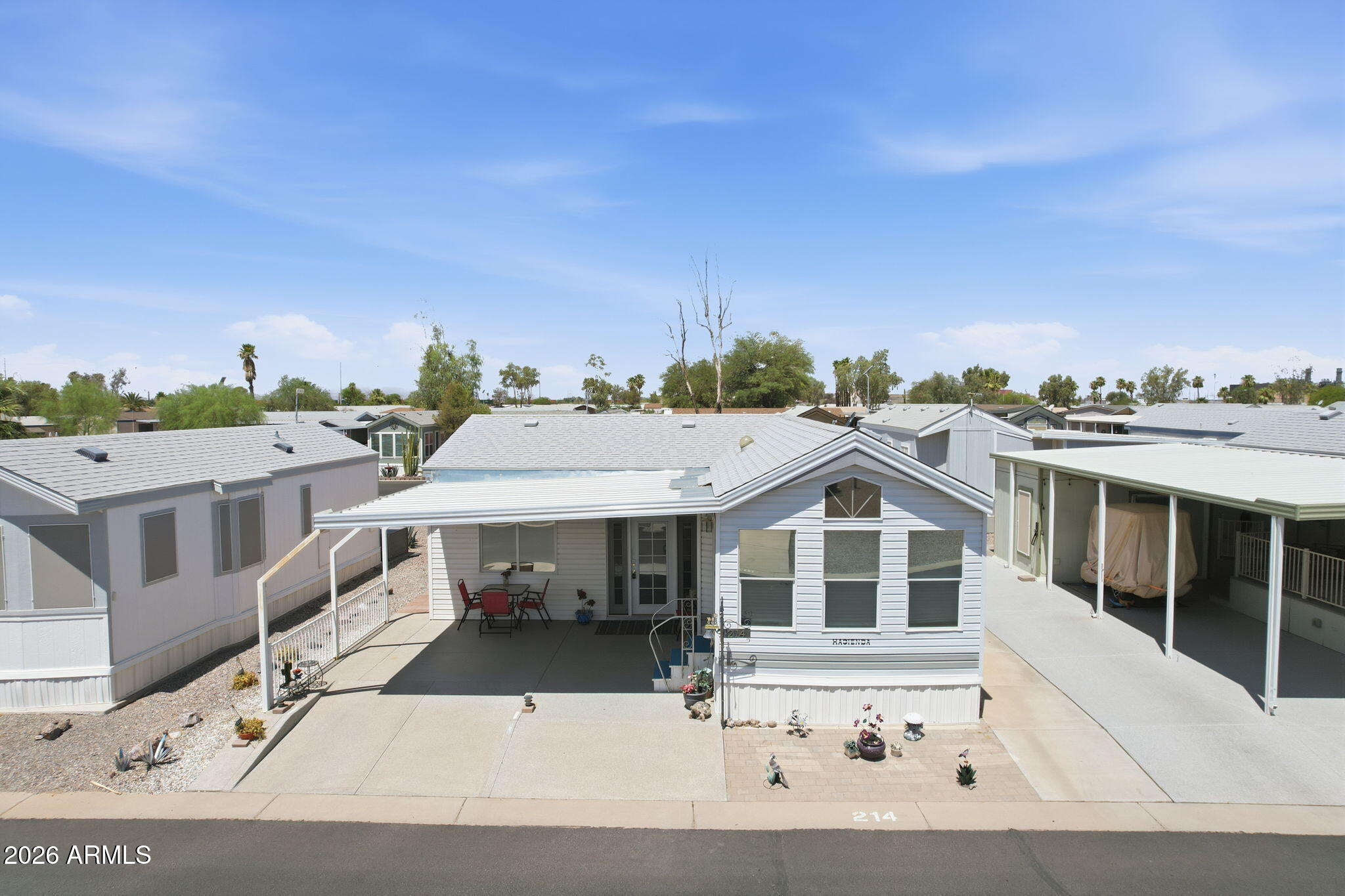Enjoy the active 55+ lifestyle in Sundance 1 RV Resort! This well-maintained 1-bedroom, 1.5-bath home features an expansive Bonus room (approx. 225 sq. ft.), providing exceptional bonus living space for entertaining, relaxing, or hobbies. A separate 10' x 12' utility room offers washer and dryer hookups, a convenient half bath, and ample space for storage. The galley kitchen features a pantry, new refrigerator, freshly painted cabinetry (2022), and new flooring in the kitchen, bath, and bedroom. The spacious bedroom includes built-in drawers and a large closet. Additional updates include interior paint (2022), a walk-in shower, sunshades, and a paver patio. Enjoy resort-style amenities, endless activities, and a welcoming community just minutes from shopping, dining, and I-10.