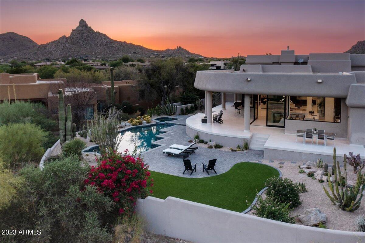 Seller will provide $20,000 credit to buyer at closing towards primary closet. *Full list of improvements in documents tab* 
Fully renovated home in guard gated community of Windy Walk. On the 6th fairway of Troon Country Club's private course with views of Troon Mountain and Pinnacle Peak! This home is a perfect entertainment house with multiple walls of windows opening to the extended covered patio, fully refinished pool and spa with new equipment and a bar that opens to the outside for the ultimate pool party setup. Large kitchen offers an oversized island with abundant seating space, custom cabinetry, Wolf and Sub-Zero appliances plus a butler's pantry. Additional fridge/freezer, dishwasher, sink with garbage disposable, warming drawer and ample storage in the butler's pantry. Downstairs primary bedroom with patio access, mountain views, seating room, fireplace, luxury bathroom and oversized closet with laundry hook up. All three guest rooms have en suite bathrooms. Home renovations are almost complete. There are several items still being finished but will be completed prior to closing.