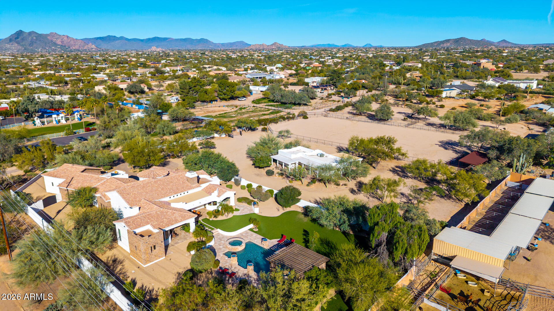 This listing is for the Main House + Guest House + Vacant Land listing only. Please see MLS#6971415 & MLS#6971383 for additional configurations for the Main House only OR the Main House + Guest House together. 

NESTLED on an oversized corner lot & featuring 4,666 sq ft with a stunning facade w/ tasteful stone accents, a manicured low-care landscape, a 4-car oversized garage w/ built-in cabinets, and a circular paver driveway. Come inside to discover a welcoming circular foyer, which flows seamlessly into a spacious great room showcasing high ceilings w/ exposed wood beams, a wet bar, and an impressive fireplace to keep you warm during the cold winter months. Travertine stone flooring, dazzling light fixtures, and neutral palette throughout! The gourmet kitchen is worthy of a chef, equipped w/ ample cabinetry, a walk-in pantry, granite countertops, honeycomb tile backsplash, SS appliances, and a center island w/ a breakfast bar for casual dining. The kitchen includes 2 dishwashers, 1 subzero refrigerator, and 1 Wolf double oven. If you like entertaining, you will love the dining area that is conveniently located off the kitchen where you can enjoy formal meals with family or friends in style.  

You'll be amazed by the grand master bedroom, with plush carpet, a huge walk-in closet with built-in shelving and washer & dryer hookups, a 2nd fireplace, and a lavish ensuite bathroom w/ dual vanities, a large tiled shower,  plus a jetted tub. The secondary bedroom can be used as a mother-in-law suite or second master bedroom with a separate entrance to the backyard with  its own private bathroom as well as a dry bar.  The remaining 2 bedrooms are ample size with their own private bathrooms.  There is a separate laundry room inside with plenty of storage and a utility sink. 

Outside, you will find a huge resort-style backyard includes a covered travertine patio & decking, extended seating areas, nice size grassy area for outdoor sports, a built-in BBQ area, a lovely pergola, a sparkling blue pool, and a refreshing spa. 

Separate guest house included in this listing features 2-bedrooms, 2-bathrooms, 2-carport spaces, plus its very own living room and kitchen w/ blue glazed tile countertops and Saltillo tile throughout. There is paver parking under the carport.  The washer & dryer will convey. Interior paint (2024) & exterior paint (2026). 

The backyard is very spacious and is adjacent to the main house to the west & vacant land to the east. A designated septic system is included with the guest house. 

The vacant land included in this listing features the roping arena, a 3-stall mare motel, and (4)- 40 x 40 horse pens (turn-outs) for horses!

The main house includes 4,666 square feet APN# is 211-44-070-C. The guest house includes 1,160 square feet APN# is 221-44-070-B. The vacant land includes 2.318 acres APN# is 221-44-059-A.

All three MLS#6971325, 6971383, and 6971415 must be sold as specified on MLS. No portion of the listing can be sold separately other than the main house.