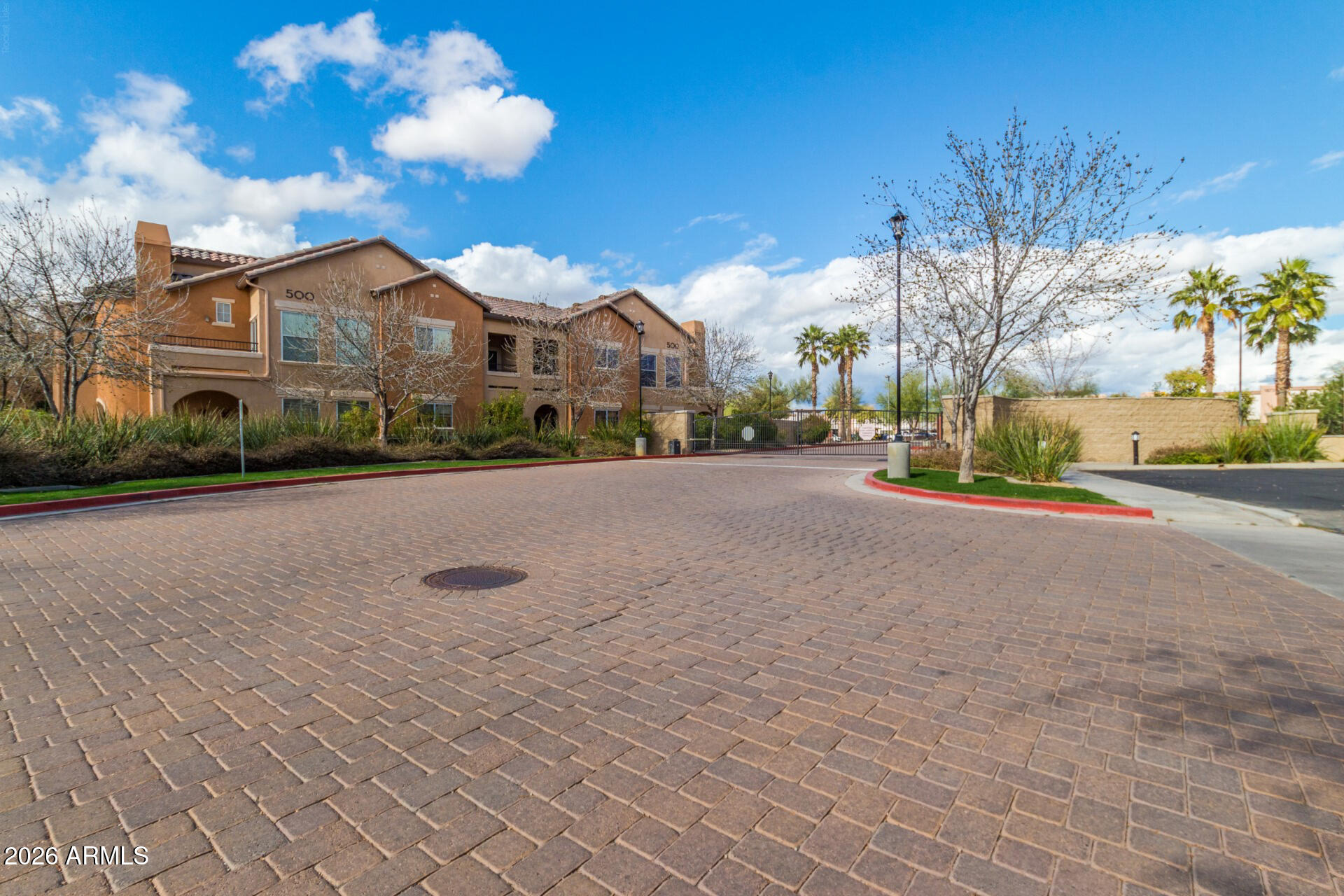 Discover this beautifully maintained upstairs unit in gated Park Place. Inside, enjoy tall ceilings, wood-look tile flooring, baseboards, natural light, and warm, timeless finishes throughout. The layout includes a formal dining area and spacious living room for easy entertaining. The kitchen features granite countertops, stainless steel appliances, recessed lighting, staggered cabinetry, and a breakfast bar with serving hutch. The bedroom includes a walk-in closet, while the bathroom offers dual granite sinks. A flexible den adds options for a home office or guest room. Step out to a private balcony for outdoor relaxation. Assigned parking included. Community amenities include a pool, spa, clubhouse, fitness center, yoga room, business center, and theatre room.