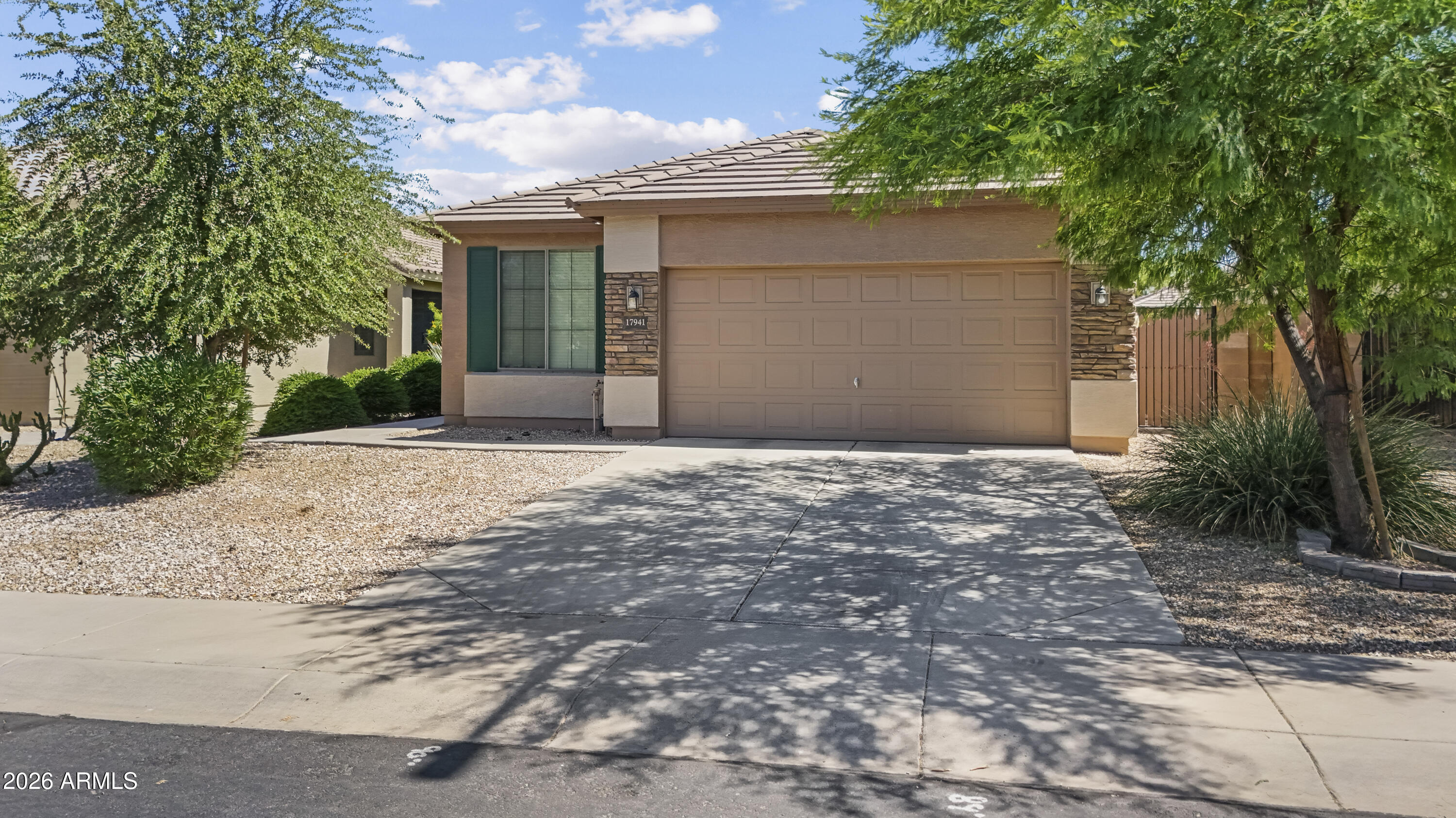 This well-maintained home offers a fantastic opportunity for first-time buyers or investors ready to add their own cosmetic touches and build equity. Major systems have been responsibly cared for, including regular annual HVAC maintenance.
The functional split floor plan features well-sized bedrooms, an eat-in kitchen with generous counter space, and upgraded cherry cabinetry. A den provides additional space for a home office, playroom, or guest area.

The primary bathroom is ready for a buyer's personal vision, with the bathtub removed to create an enlarged shower area and additional open space that offers excellent remodeling potential. New carpet and cosmetic updates will help make this home truly shine. The backyard offers added privacy with no two-story homes behind and includes existing garden beds, decorative rock, and space for buyers to reimagine the landscaping and outdoor living areas to suit their style. The low-maintenance desert front yard complements the beautiful West-facing mountain views.
Conveniently located just minutes from the Loop 303, White Tank Mountain Regional Park, shopping and dining. This 3-bedroom plus den, offers excellent potential in a desirable location.