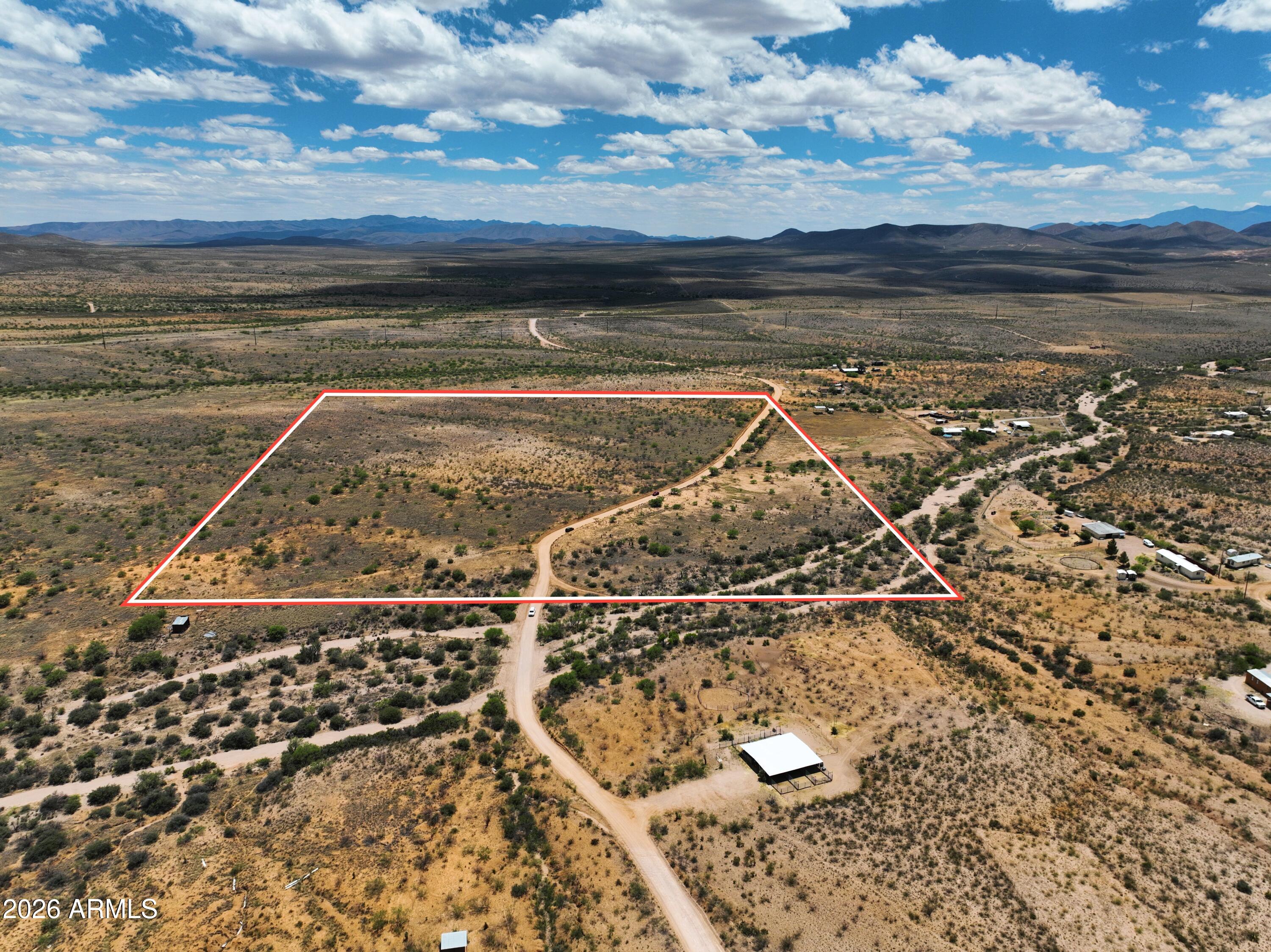 This 30+ acre parcel in Cochise County offers flat, usable terrain with mountain views and approximately 4,500 ft elevation, providing a straightforward setup for future development. Electric and water are nearby, reducing initial infrastructure planning. Zoned RU-4, the property allows for single-family homes and mobile homes, with potential for a lot split subject to county requirements. Seller may be willing to split the lot. Located just minutes from Tombstone, approximately 35 minutes to Sierra Vista, and about an hour to Tucson, the property combines rural space with access to nearby services. The open landscape and wide frontage provide flexibility for building or holding as a long-term investment. If you are looking for large acreage in Southern AZ this one is great!