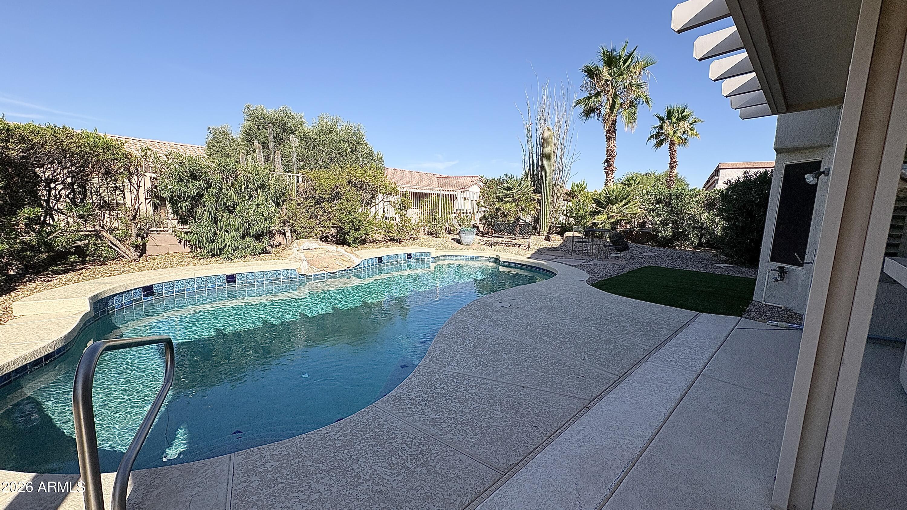 Enjoy a cold lemonade in your newly renovated pool. Move-in ready home with fresh exterior paint completed in 2023. Features include plantation shutters, ceiling fans, central vacuum, garage cabinets, and a recirculating whole-house hot water system. Kitchen appliances convey, including refrigerator, oven/range, microwave, and disposal. Washer, dryer, and laundry sink are also included.
Enjoy the beautifully renovated backyard oasis featuring a Pebble Sheen pool finish with tile surround, jet spa with bench seating, rock waterfall, and a variable-speed pump with popup cleaners. A well-maintained home with thoughtful upgrades both inside and out.