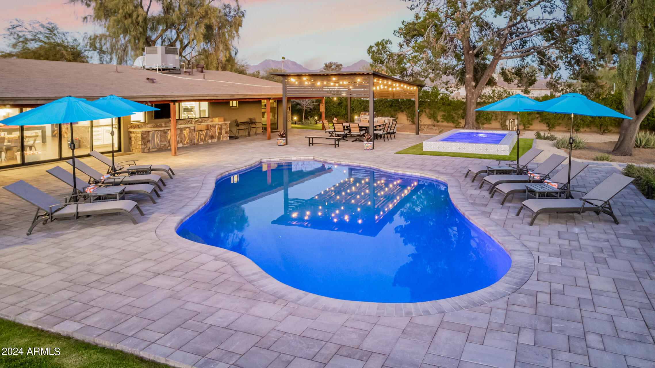 Experience the ultimate North Scottsdale lifestyle on a nearly one-acre lot just minutes from Kierland Commons & Scottsdale Quarter! This beautifully remodeled estate features over $220,000 in upgrades including a brand NEW ROOF and a seamless open-concept design ideal for both everyday living and upscale entertaining. The chef's kitchen anchors the home with an Italian marble waterfall island, premium stainless-steel appliances, and effortless flow into the expansive living space with sliding glass doors opening to the backyard. The resort-style backyard was fully redesigned in 2023 and is truly a showstopper! Enjoy a saltwater pool with new Pentair equipment, Pentair equipment, custom pergola with built-in BBQ, gas fire pit, 5-hole putting green and expansive natural grass areas. The massive lot offers incredible flexibility to add a casita, guest house, or additional outdoor amenities, making this property ideal for future expansion or multi-generational living. Generously sized bedrooms include dual primary suites, private patio access, and versatile bonus space. Offering rare privacy, endless outdoor potential, and close proximity to world-class shopping, dining, Scottsdale Airport (SDL), and Downtown Scottsdale, this is a true North Scottsdale sanctuary that blends luxury, lifestyle, and long-term value.
