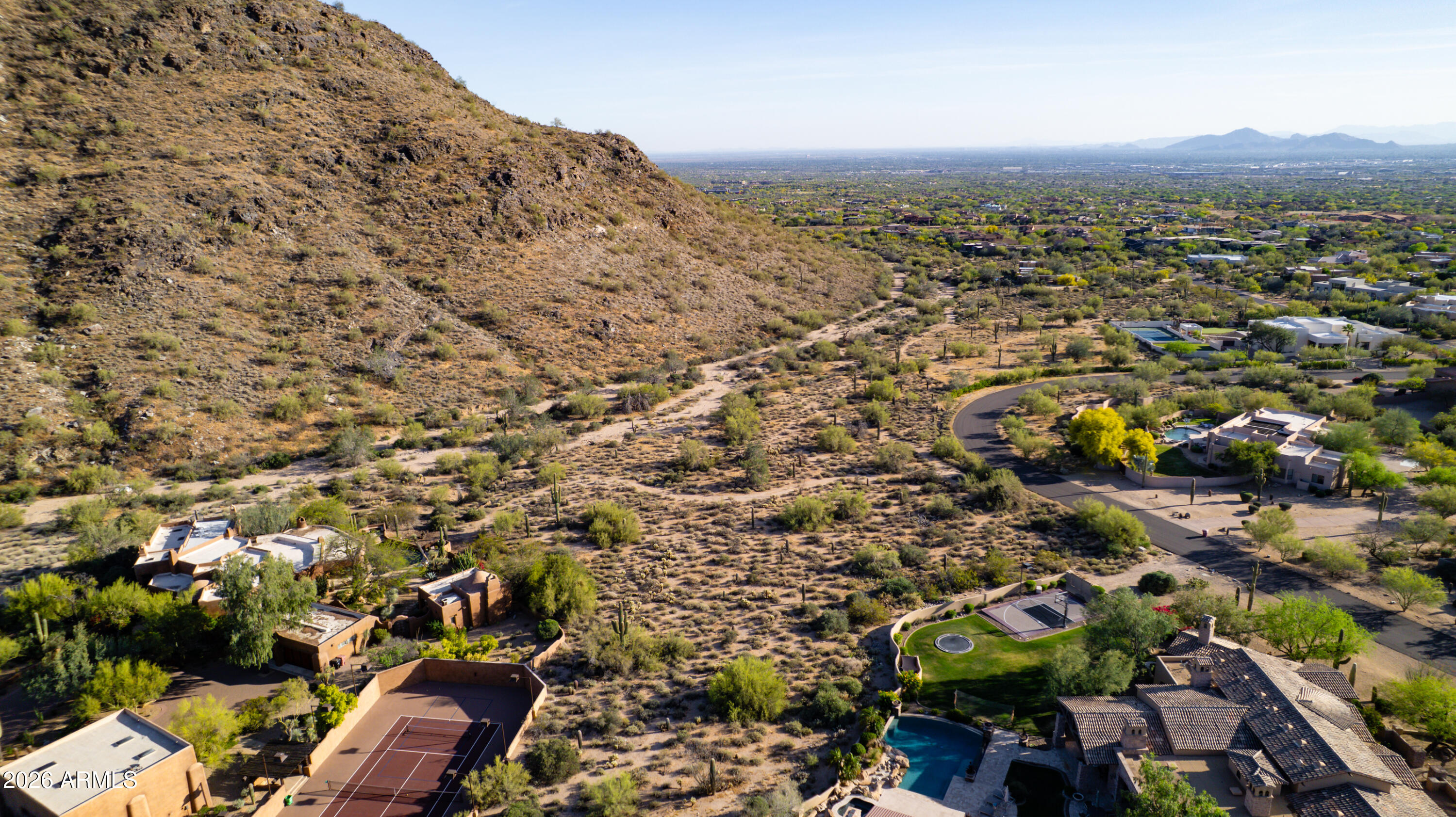 Situated within the esteemed custom-home enclave of Pinnacle Peak Heights, this exceptional homesite spans nearly three acres at the base of the McDowell Mountains, capturing sweeping Sonoran Desert and city-light views. Ideally positioned in one of North Scottsdale's most desirable locations, this buildable lot offers a rare opportunity to create a custom estate surrounded by natural beauty, privacy, and elevated desert landscape. A truly special offering in a premier setting.