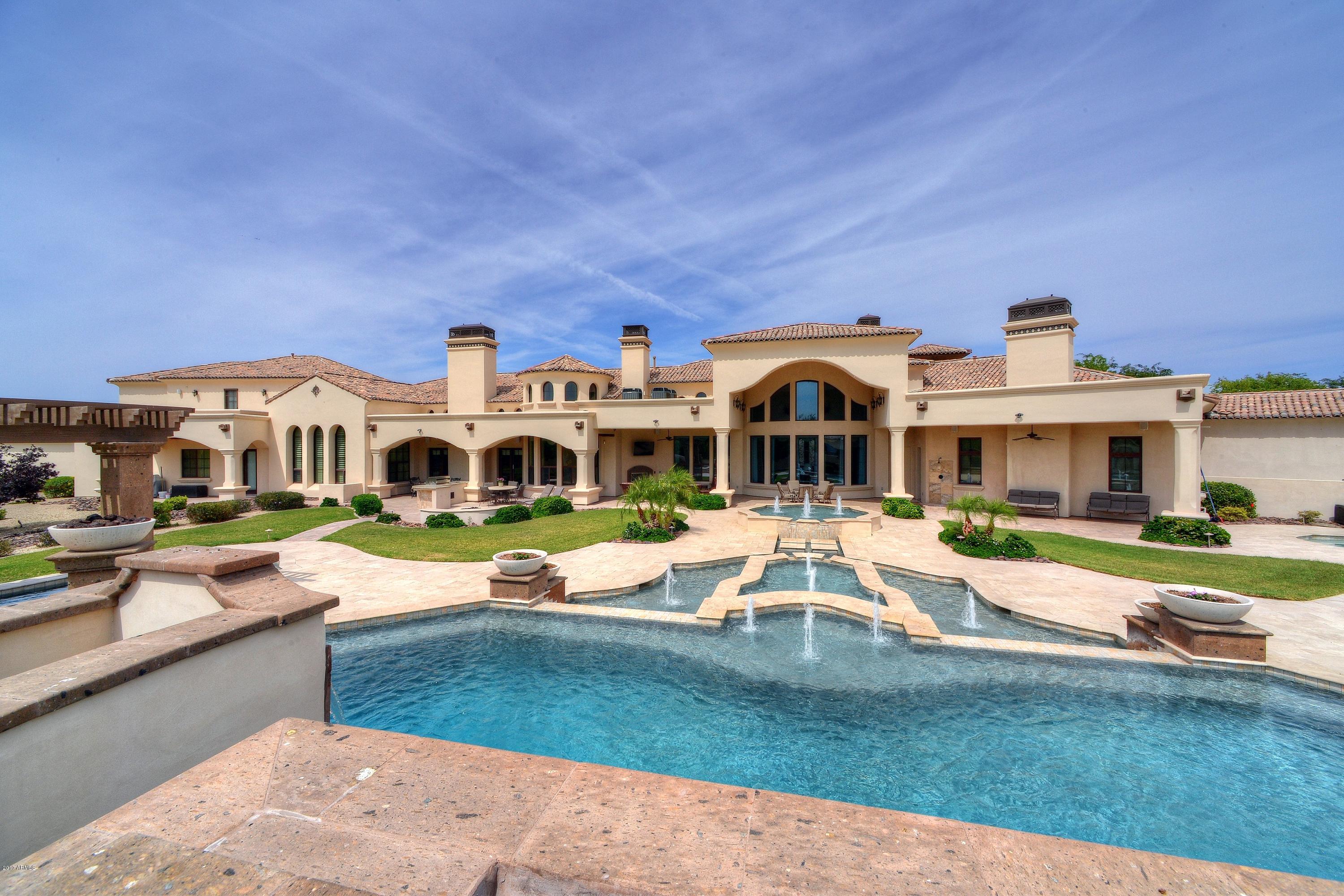 EXCLUSIVE GATED LEGACY ESTATES Custom MASTERPIECE!  A RARE opportunity to own your private LUXURY RESORT w/ 3 SEPARATE POOLS, INCLUDING YOUR VERY OWN LAZY RIVER!  First time to ever grace the market, this extraordinary estate is brimming with elegance & grandeur. Perfectly sited on 1.78 acres of breathtaking professional landscaping, the single level 10,200 sf, 7BR/7.5BA estate is the essence of harmoniously blended graceful architecture and unsurpassed handcrafted detail. The gated private grounds add spellbinding allure with multiple fountains, an elegant main pool w/ dual slides, various firepots, play pool, lazy river, spa, expansive covered patios w/ custom wood ceiling details, outdoor fireplace & outdoor BBQ area. Dramatic Hand-hewn wood beam & Venetian plaster ceiling variations throughout. Gourmet kitchen w/ custom Alder wood cabinetry, granite counters & all Viking appliances: induction cooktop, dual convection ovens, dual built-in fridge, built-in microwave & warming drawer.  Romantic Oversized Master Suite is fit for royalty & the offers the ultimate in luxury w/ private fireplace, venetian plaster ceiling, stone floors, marble counters, his & her custom closets, rain-head shower, intimate courtyard vignette w/ fountain & exercise room w/ bath. Grandly scaled rooms include executive office w/ custom woodwork & built-ins, billiards/game room, theater room, Jr. Suite w/ kitchenette, 4 Canterra stone gas fireplaces, private apartment casita with full kitchen, 1 bedroom/1 bath, living area and 2 balconies, extended 6 car garage w/ separate storage closets & workshop. This one-of-a-kind custom estate is truly a work of art to be appreciated!