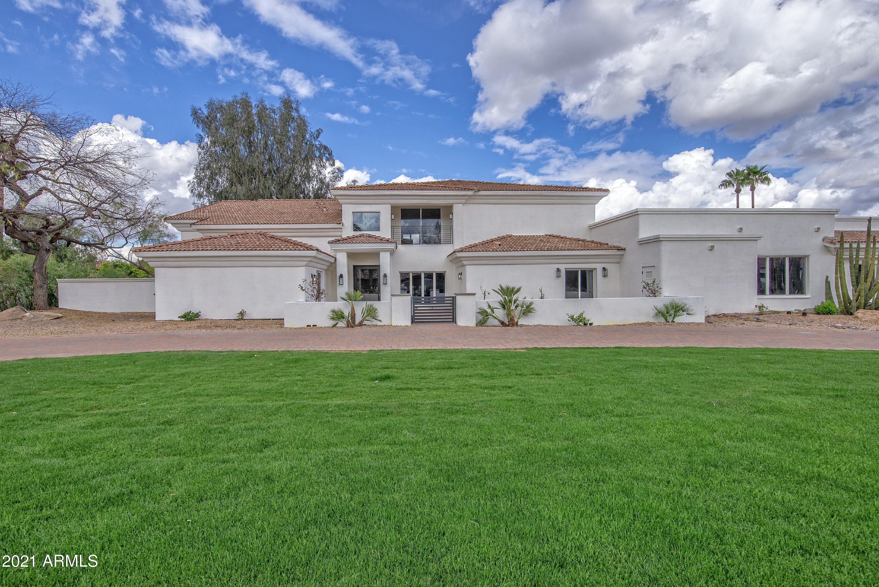 NEW PRICE!  FULL REMODEL!  TURN KEY!  Exclusive Paradise Valley neighborhood.  Fully remodeled one-of-a-kind stunning home on a great lot with views!  This 6-bedroom, 6.5 bath home has been completed remodeled to allow you to enjoy everything that this great home, lot and location has to offer.  Immerse yourself or entertain in this open concept spacious home that boasts incredible natural light throughout, allowing you to enjoy the beautiful indoor/outdoor living that Arizona is so known for.  Two incredible Master Suites await you, MASTER ON MAIN FLOOR and one upstairs, spacious great room with modern fireplace, huge family room that can be used as a game room or media room, new hardwood floors throughout, new kitchen and island, quartz counter tops, beautiful modern glass 120+ bottle wine fridge with a bar, upgraded tiling in all baths including marble tile in the master.  Huge Master has his/her separate closets and sink areas, sitting room, relaxing tub & fireplace, 2 balconies, unbelievable shower, washer/dryer and fitness room or office.  Relax in your resort style low maintenance backyard with new putting green, new gazebo with bar & BBQ, new pool, new firepit and enough space left for whatever else you can imagine.  Patios and balcony's everywhere allowing you to maximize stunning mountain views and sunsets front and back.  Excellent location, great schools, premium upscale neighborhood, impeccably remodeled modern home, turn-key ready, incredibly priced, all just waiting for you!