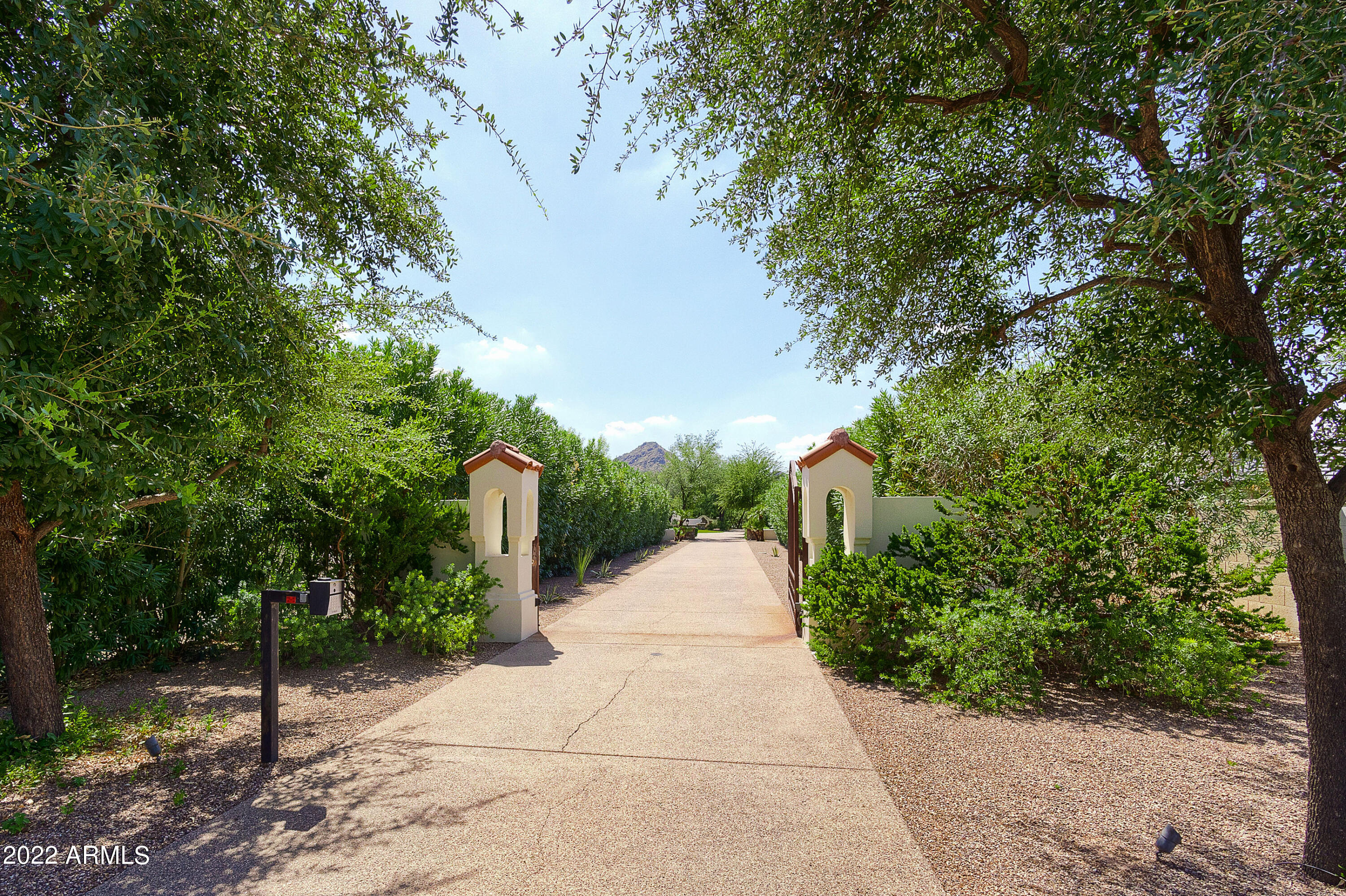 This stunning 1.5-Acre gated Flag Lot sits in arguably the best location in PV. An incredible ESTATE features a split floor plan, with all bedrooms en suite plus an exercise room, private office, cigar lounge & bar, and guest family room/library. There are so many possibilities and configurations available given the Floor Plan, SQFT, and Lot size - it truly can accommodate almost any family dynamic. On the Owner's wing there is an attached, private 2-car garage and on the guest wing there is an attached 5-car garage, with tons of storage and space for toys. Circular front drive and a private secondary gate that exits onto Stallion. Designed for grand entertaining, the backyard features an outdoor kitchen, massive diving pool with waterfall, separate built-in spa, and huge gazebo... with gas fireplace. Raised garden beds, finished storage shed, tons of grass, a children's play set, basketball, sand volleyball court, and multiple chipping/putting greens. New roof, new hot water heaters, fresh paint, whole home water filtration system, top of the line appliances in the updated kitchen, large laundry room with separate refrigerator and aside from the main laundry room, an additional stacked washer/dryer is located in the secondary wing for added convenience. You will love this fabulous home - we cant wait for you to see it!